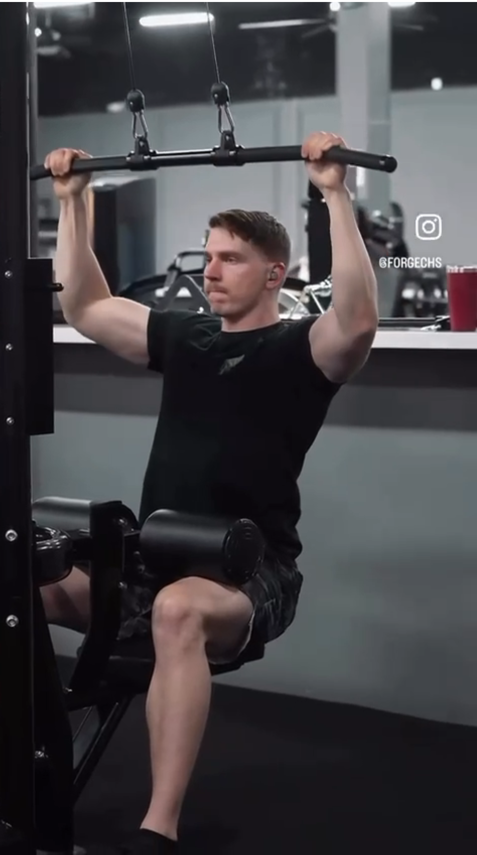 Member using lat pulldown machine at Forge CHS strength gym in West Ashley Charleston SC