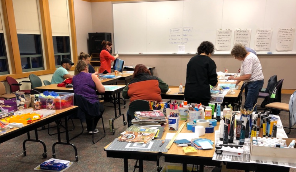 a group of people making art at a workshop