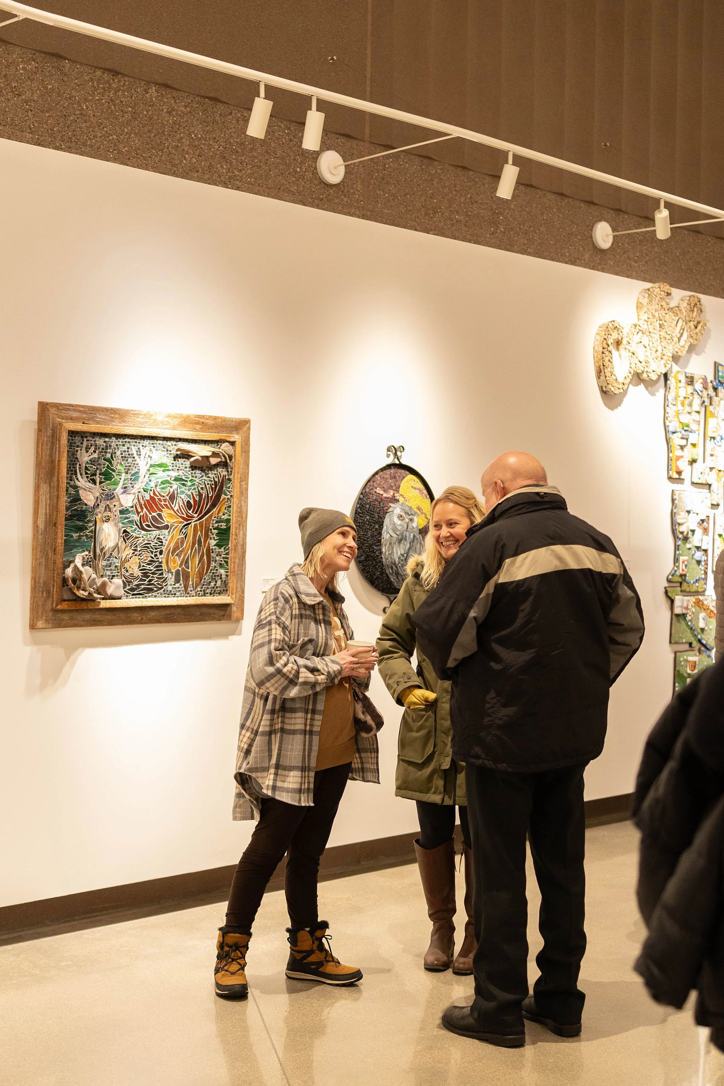 people talking during an artist reception in the RiverPlace gallery