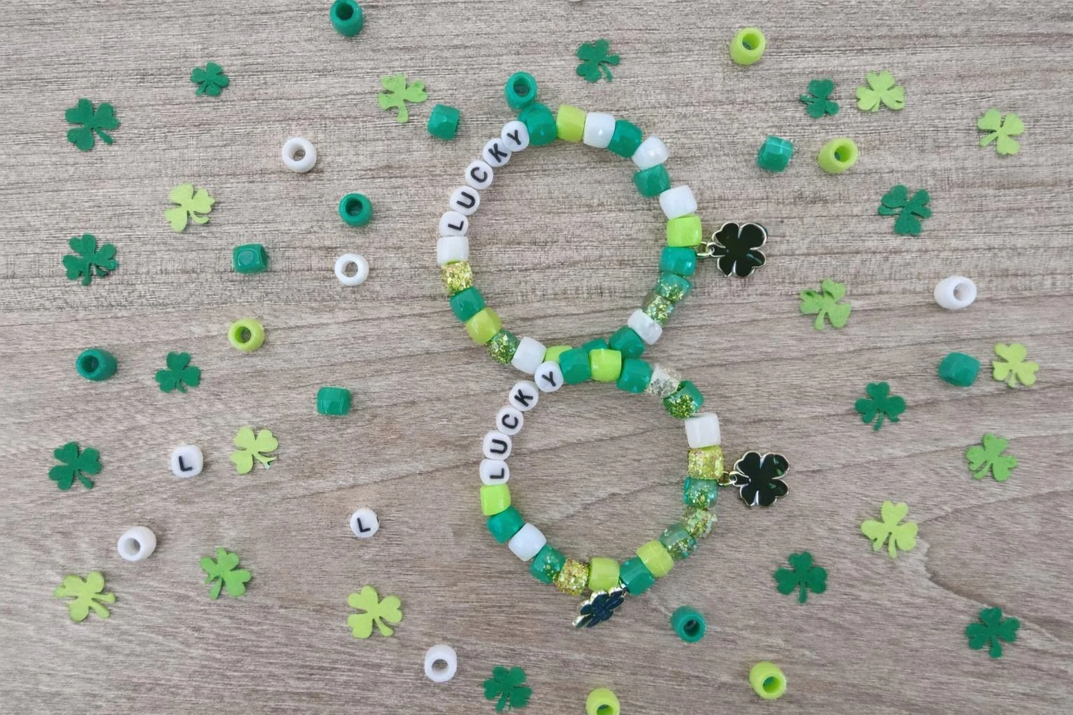 beaded bracelets that say "lucky" with green, lime green, and white beads surrounded by four leaf clover beads