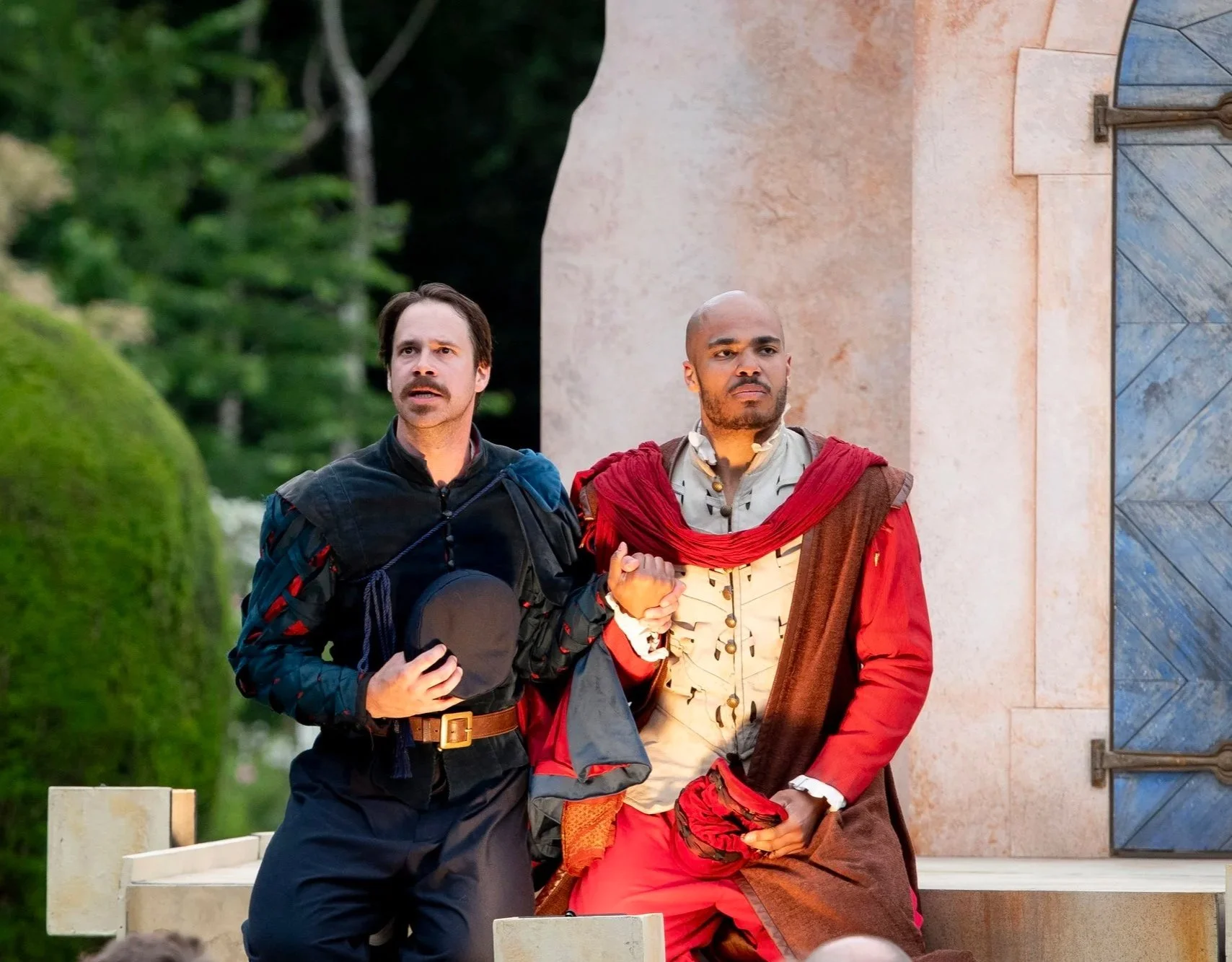two actors kneeling in Othello