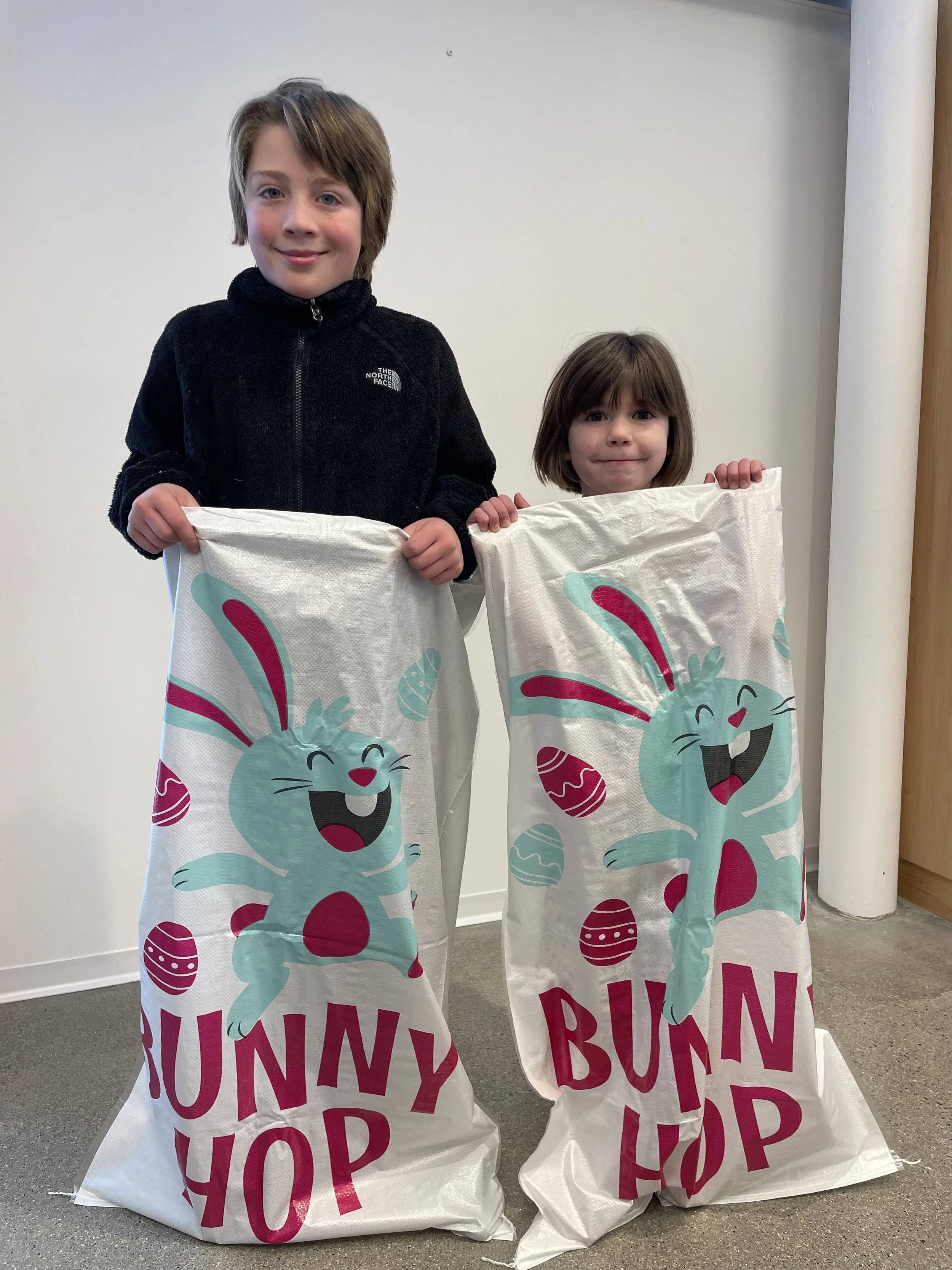 two young kids in bunny hope sack bags