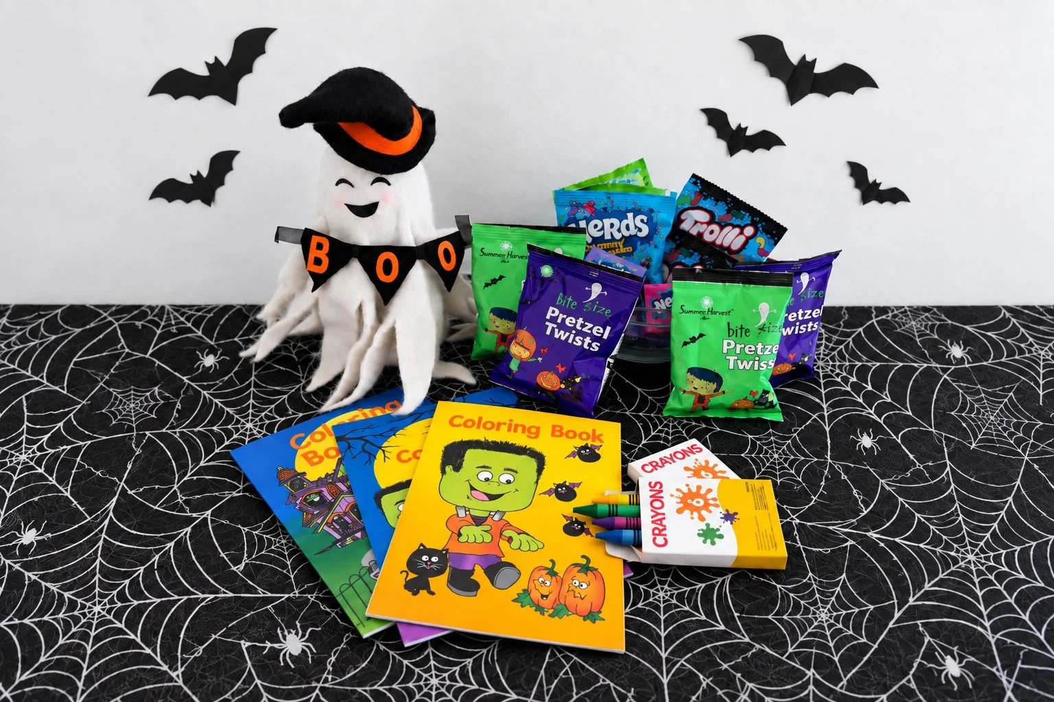 halloween coloring books and treats next to halloween decorations