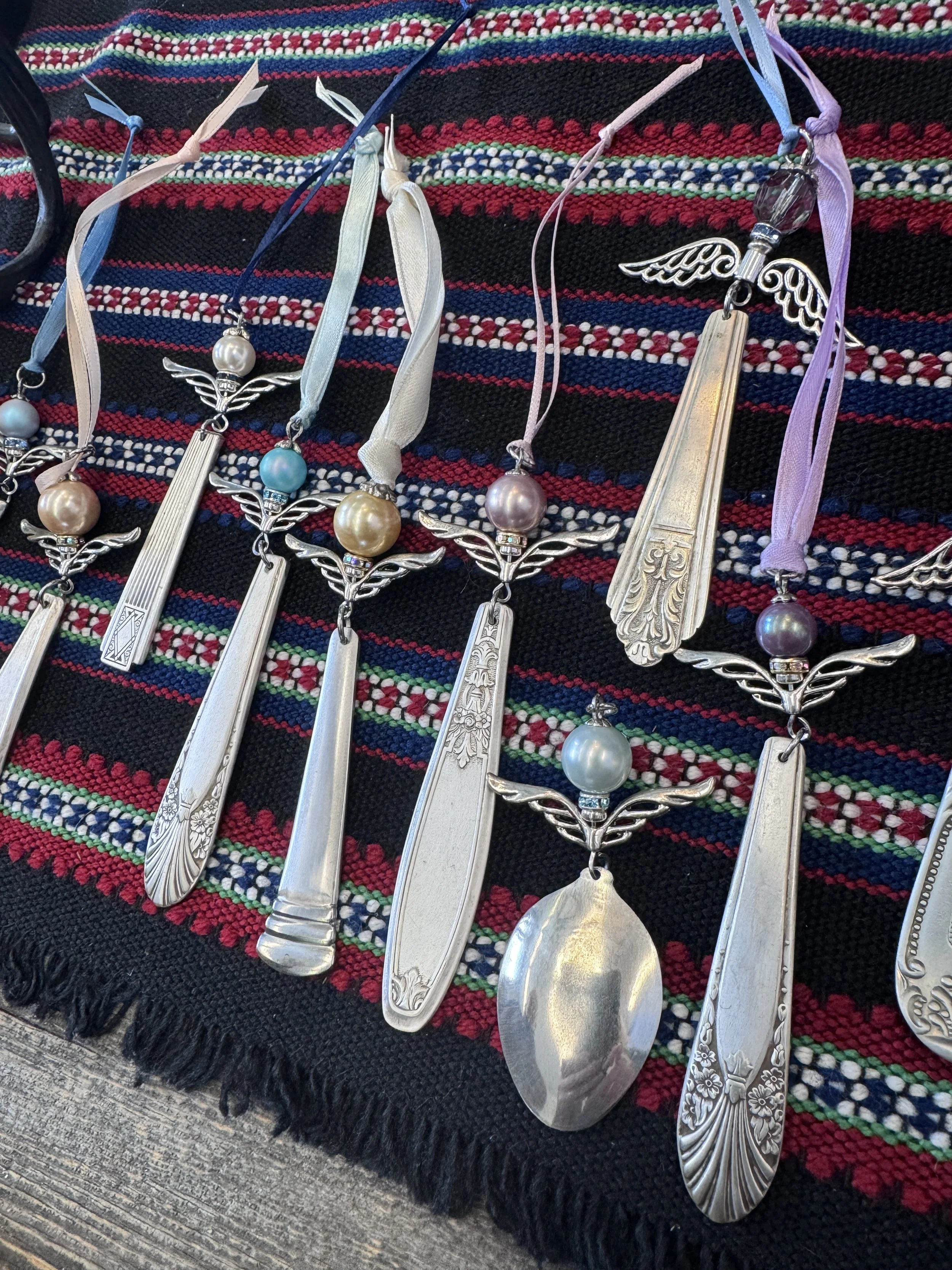 a group of flatware angel ornaments