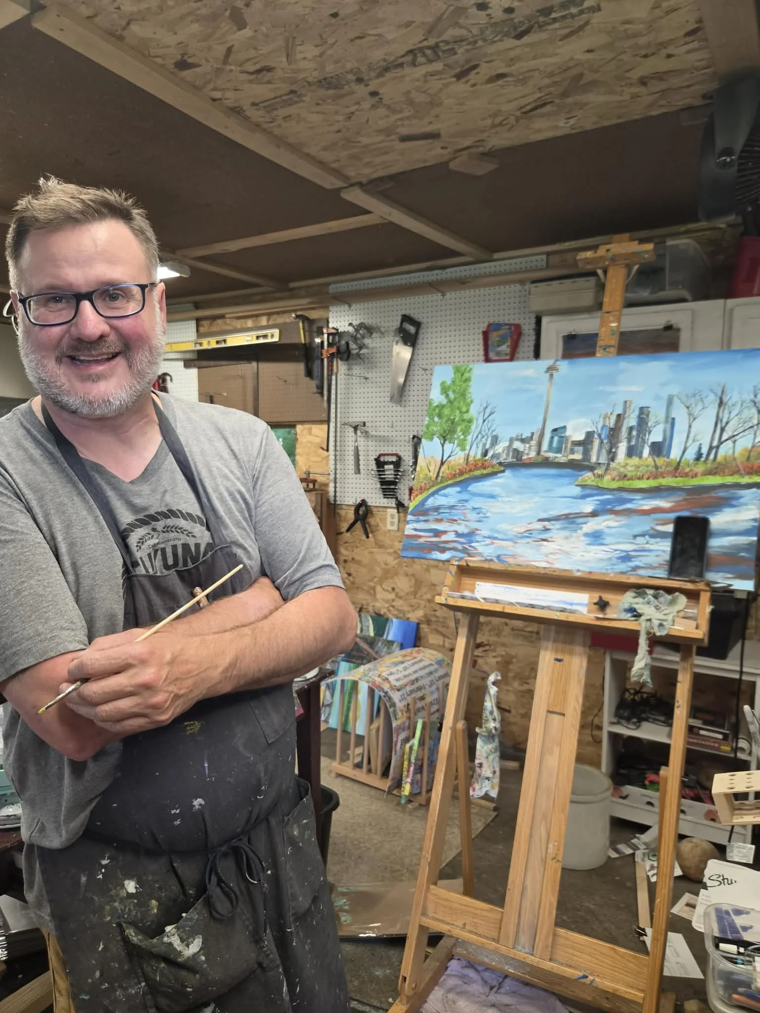 an image of artist Eric Twait painting at his studio