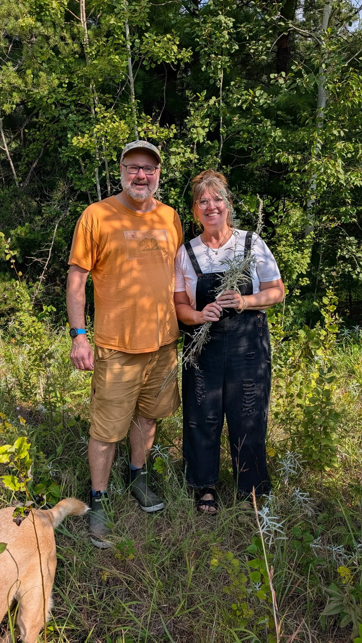 a photo of artist Eric Twait and chef Kara Super-Peterson foraging for ingredients in the woods