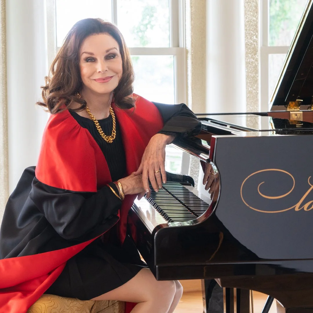 pianist Lorie Line sitting at her grand piano