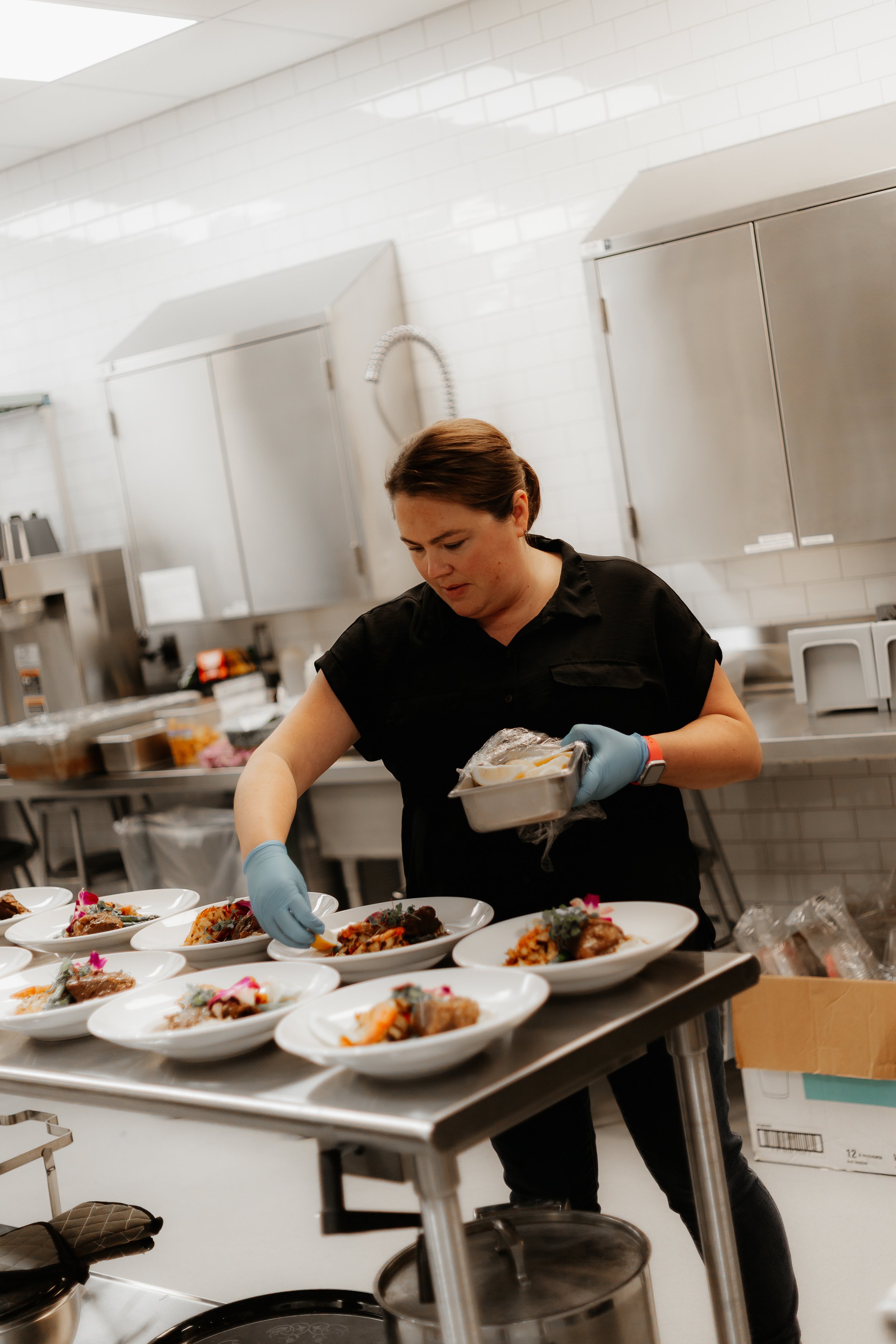 a catering chef plating food in the RiverPlace commercial kitchen