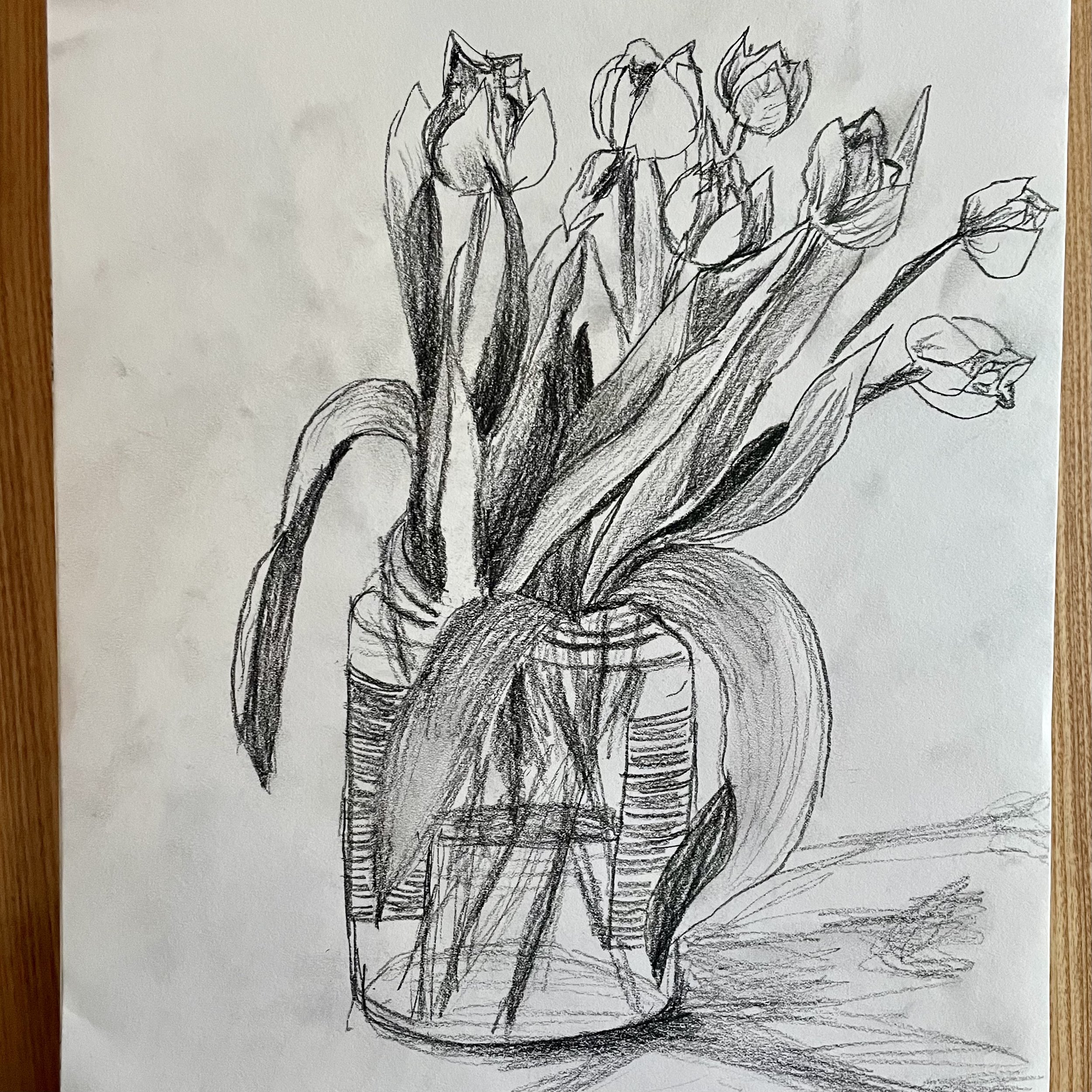 Charcoal sketch of a jar of tulips by artist Surabhi Pandey