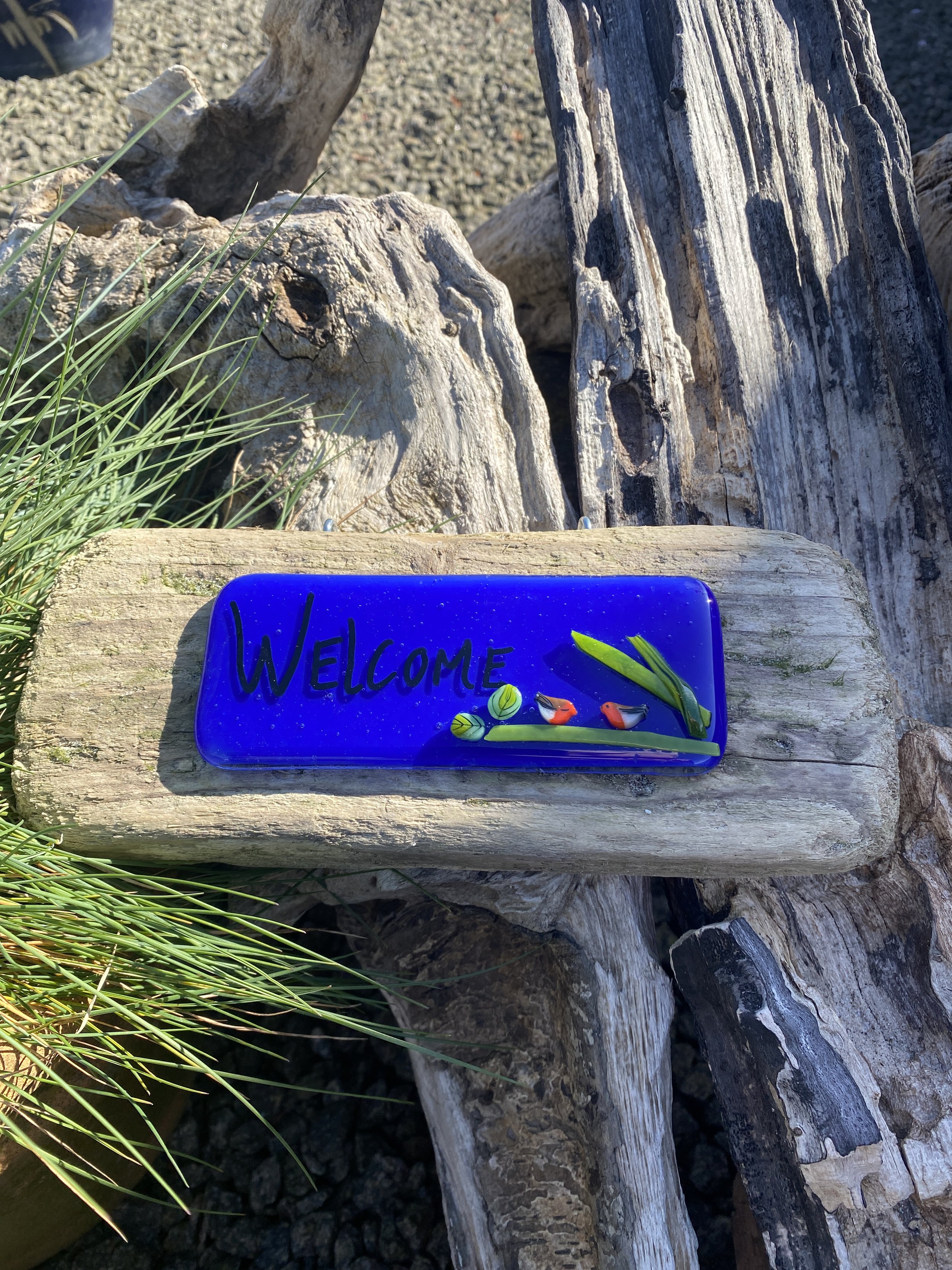 “Welcome” on driftwood