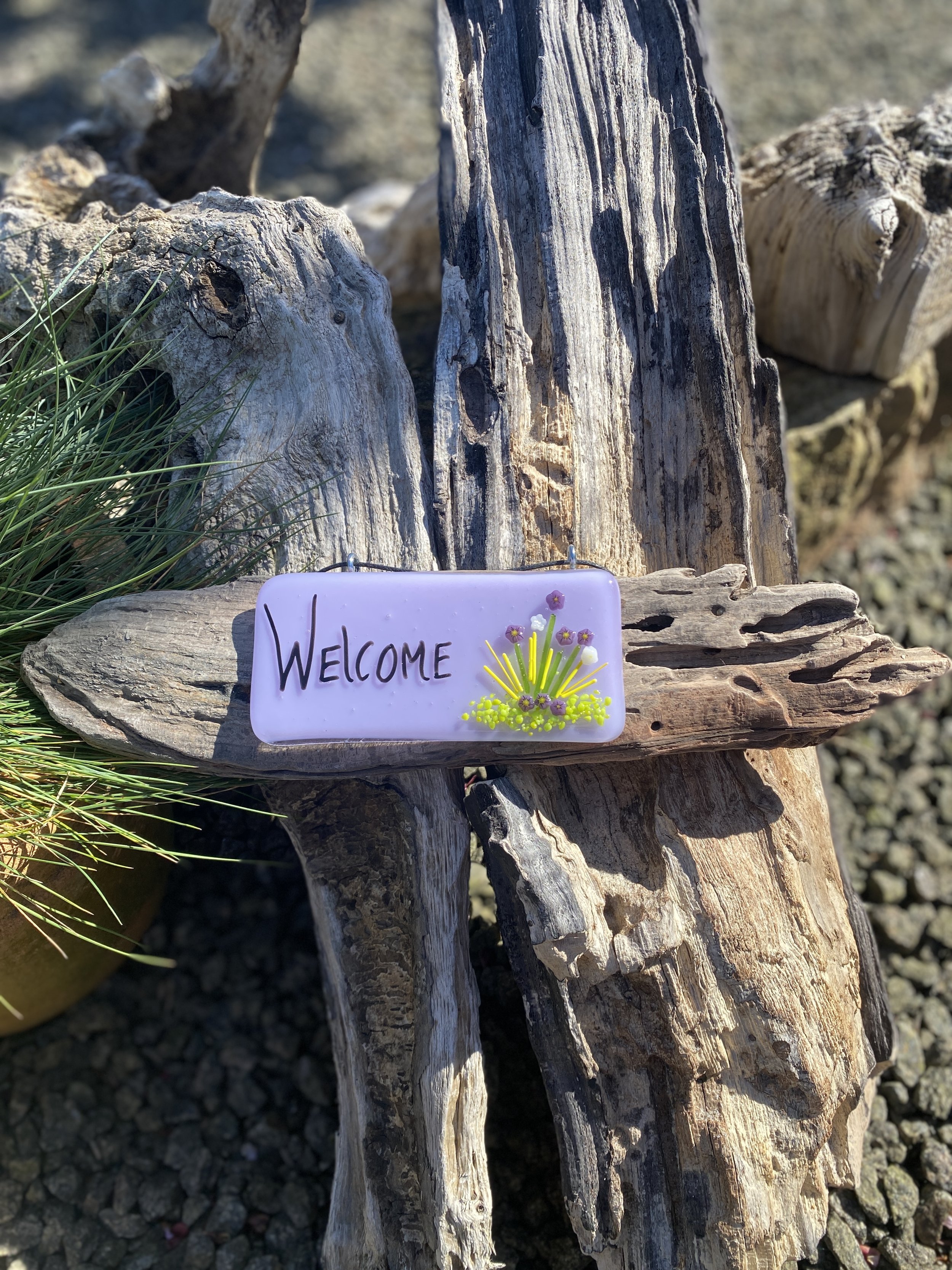 “Welcome” on driftwood