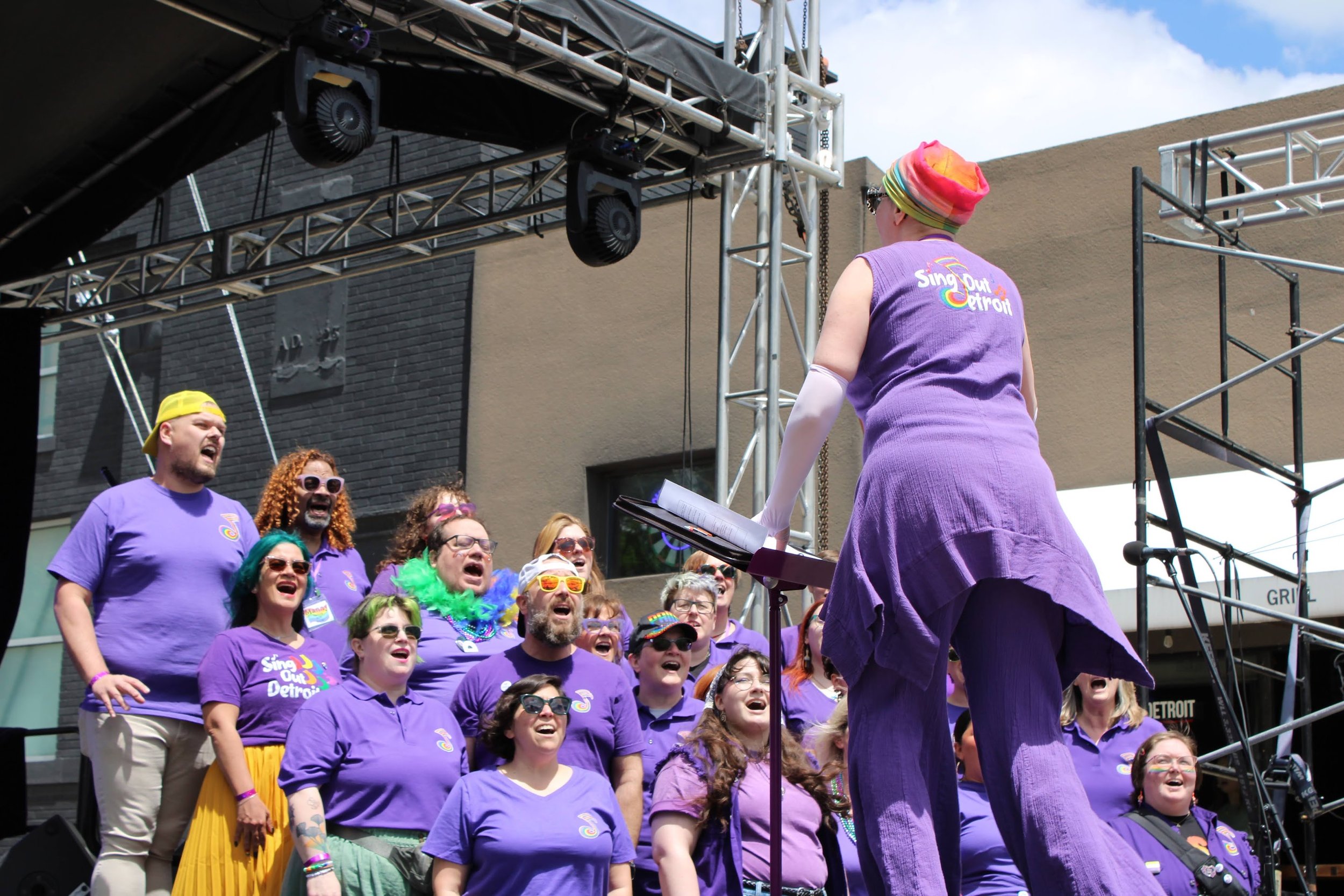 a choir sings at an outdoor festival