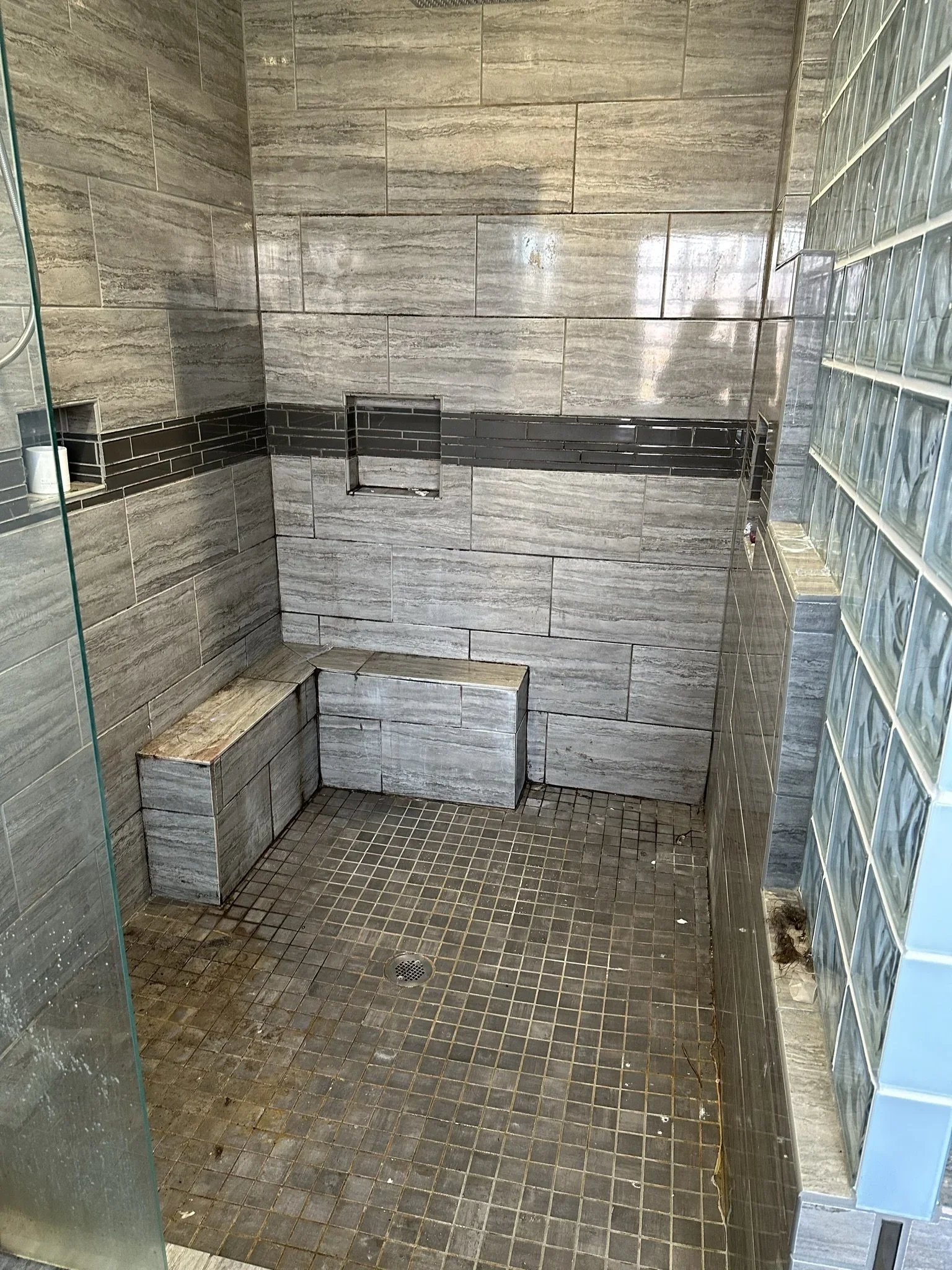 Shower Before Detailed Cleaning
Shower tile, grout, and built-in surfaces before our team began detailed bathroom cleaning.