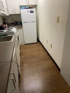 Kitchen Floor After Cleaning
A cleaner, cleared kitchen walkway after debris removal, organizing, and detailed floor care.