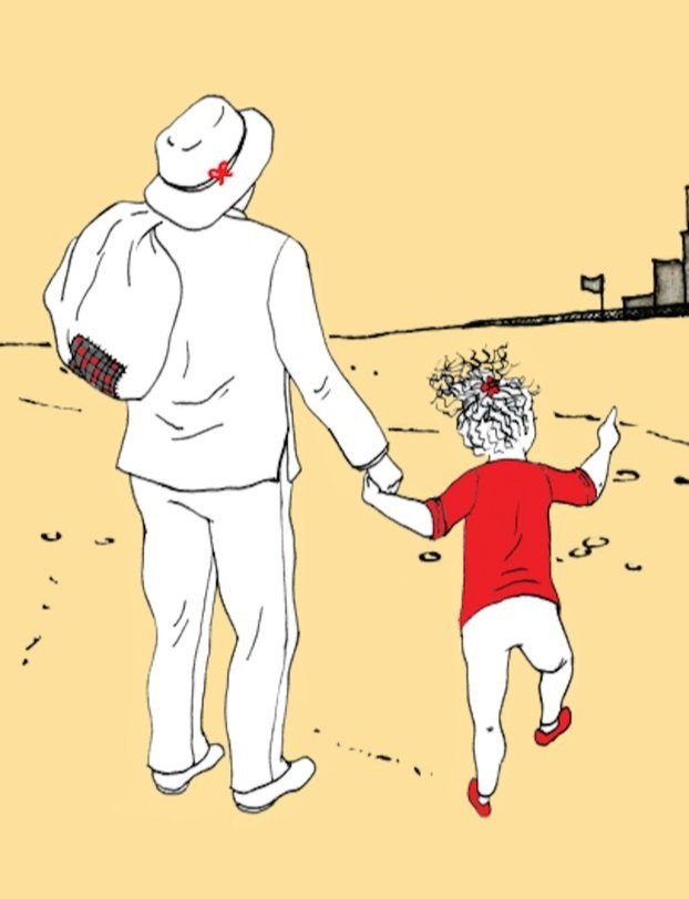 A person wearing a white outfit and hat holding hands with a small child with curly hair, wearing a red shirt and white shorts, walking on a sandy beach with a castle in the distance.