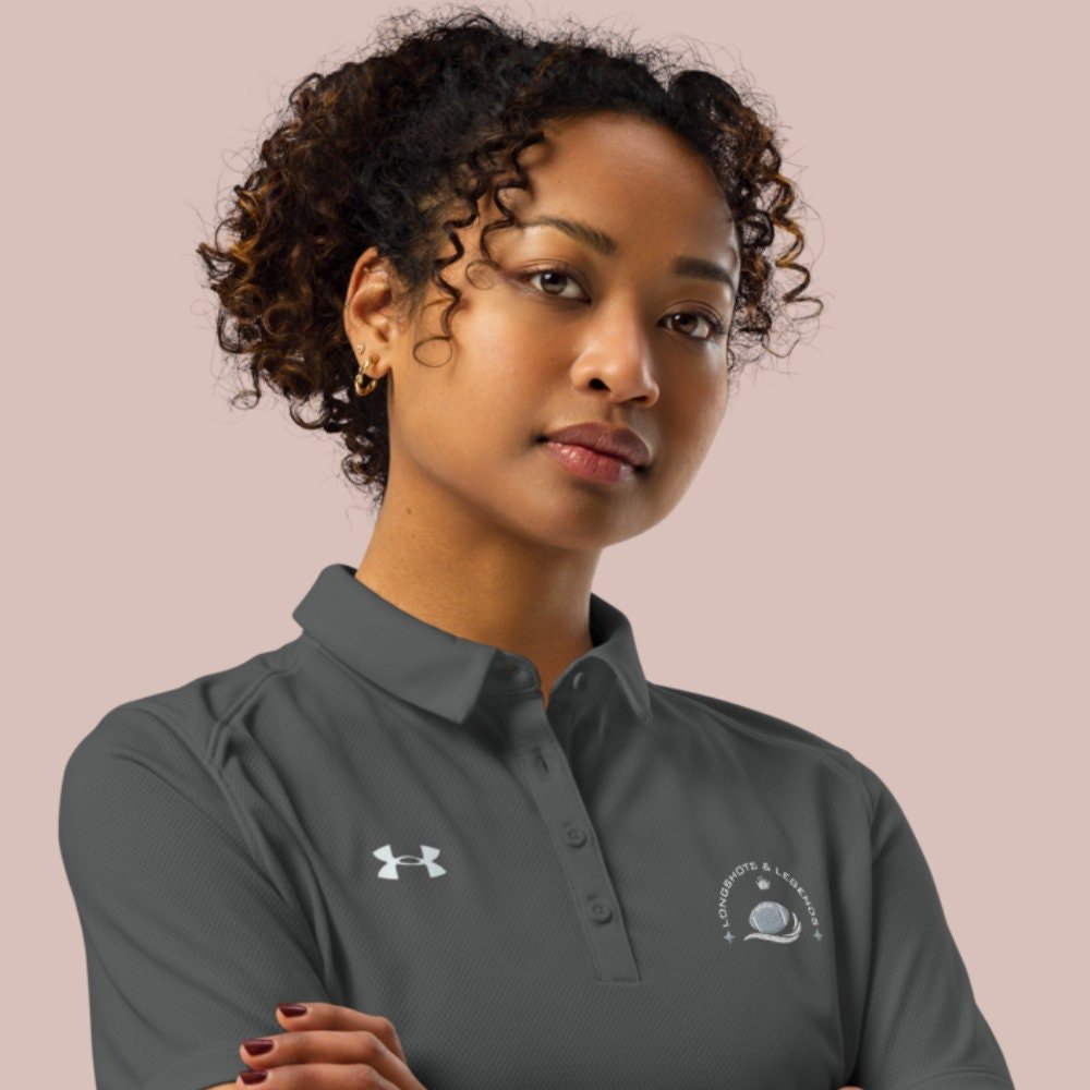 Custom embroidered women’s Under Armour® collared polo shirt with football logo in dark gray. Celebrate with the Longshots and Legends collection of athletic wear.