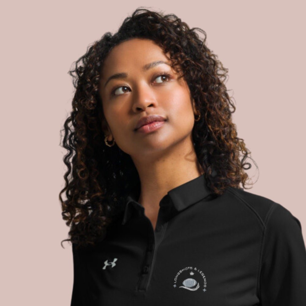 Custom embroidered women’s Under Armour® collared polo shirt with football logo. Celebrate with the Longshots and Legends collection of athletic wear.