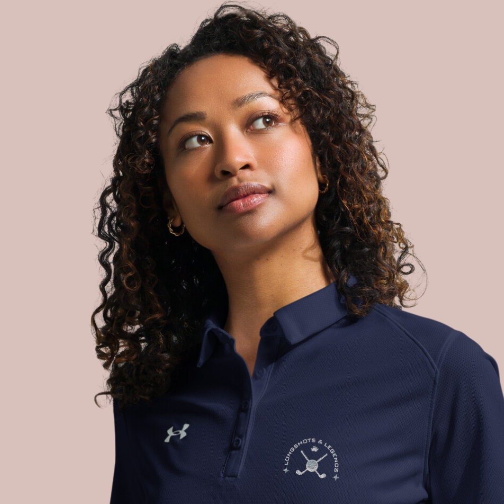 Custom embroidered women’s Under Armour® collared polo shirt with golf logo in navy blue. Celebrate with the Longshots and Legends collection of athletic wear.