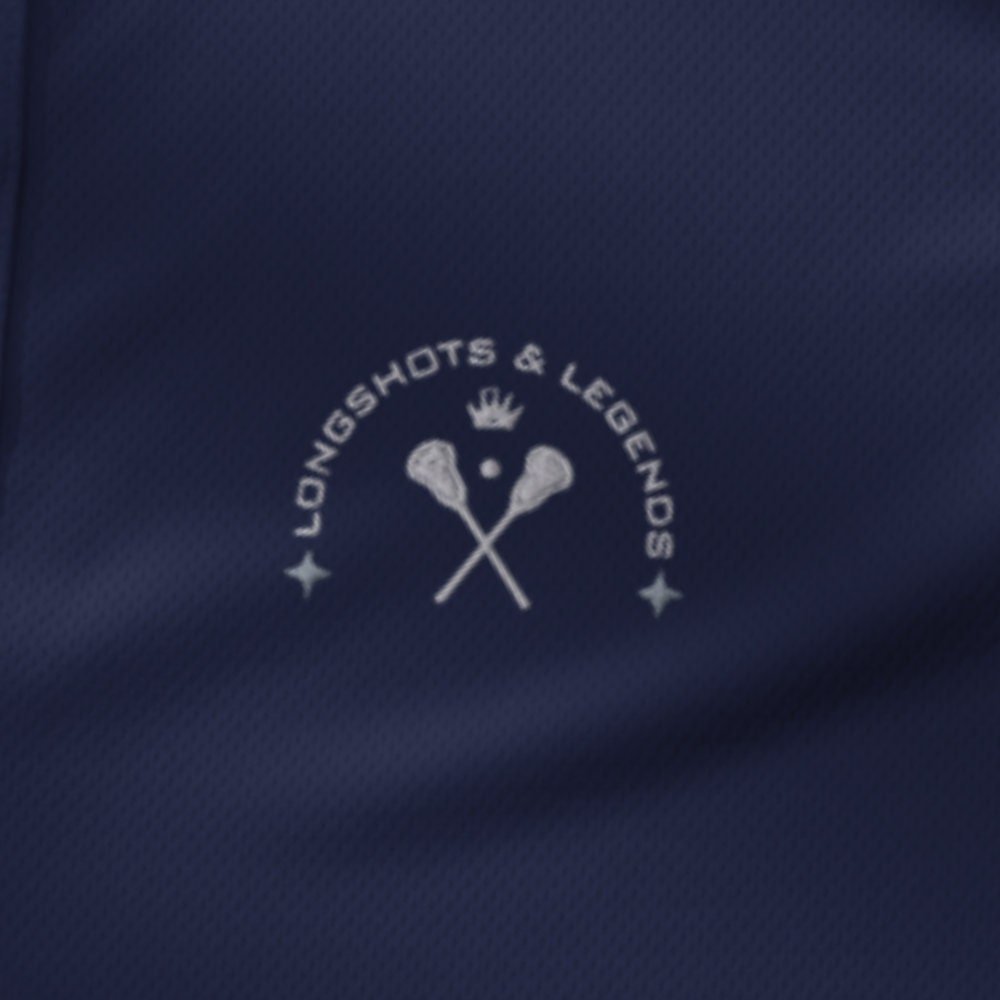 Custom embroidered women’s Under Armour® collared polo shirt with lacrosse logo in navy blue. Celebrate with the Longshots and Legends collection of athletic wear.