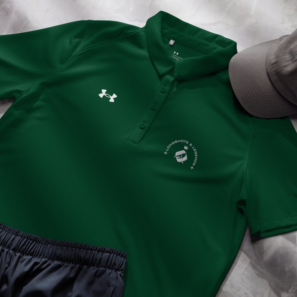 Custom embroidered women’s Under Armour® collared polo shirt with hockey logo in spruce green. Celebrate with the Longshots and Legends collection of athletic wear.