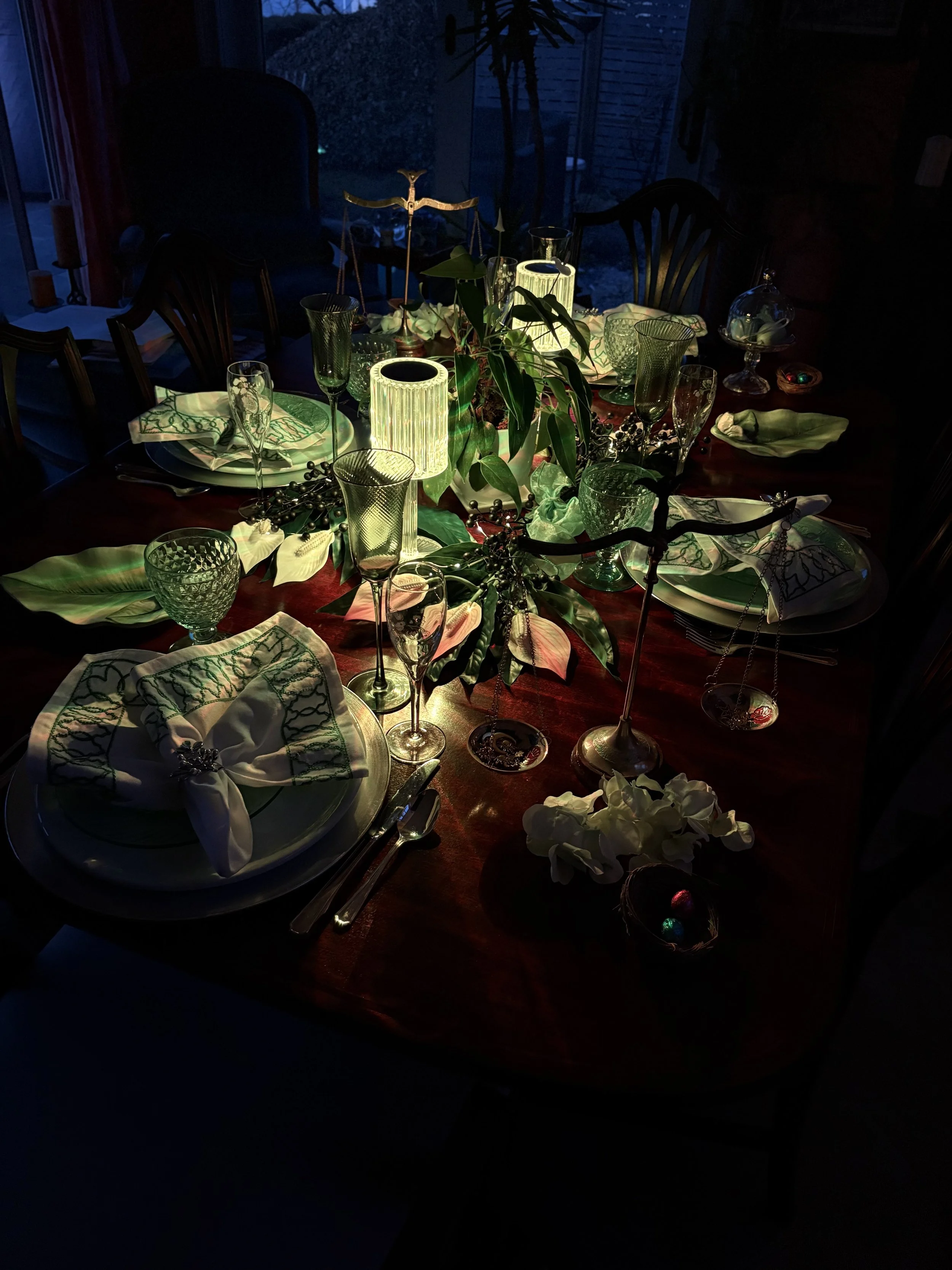  Close up of spring table setting with magnolia plates, blue eggs, and jeweled lily of the valley napkin rings.   