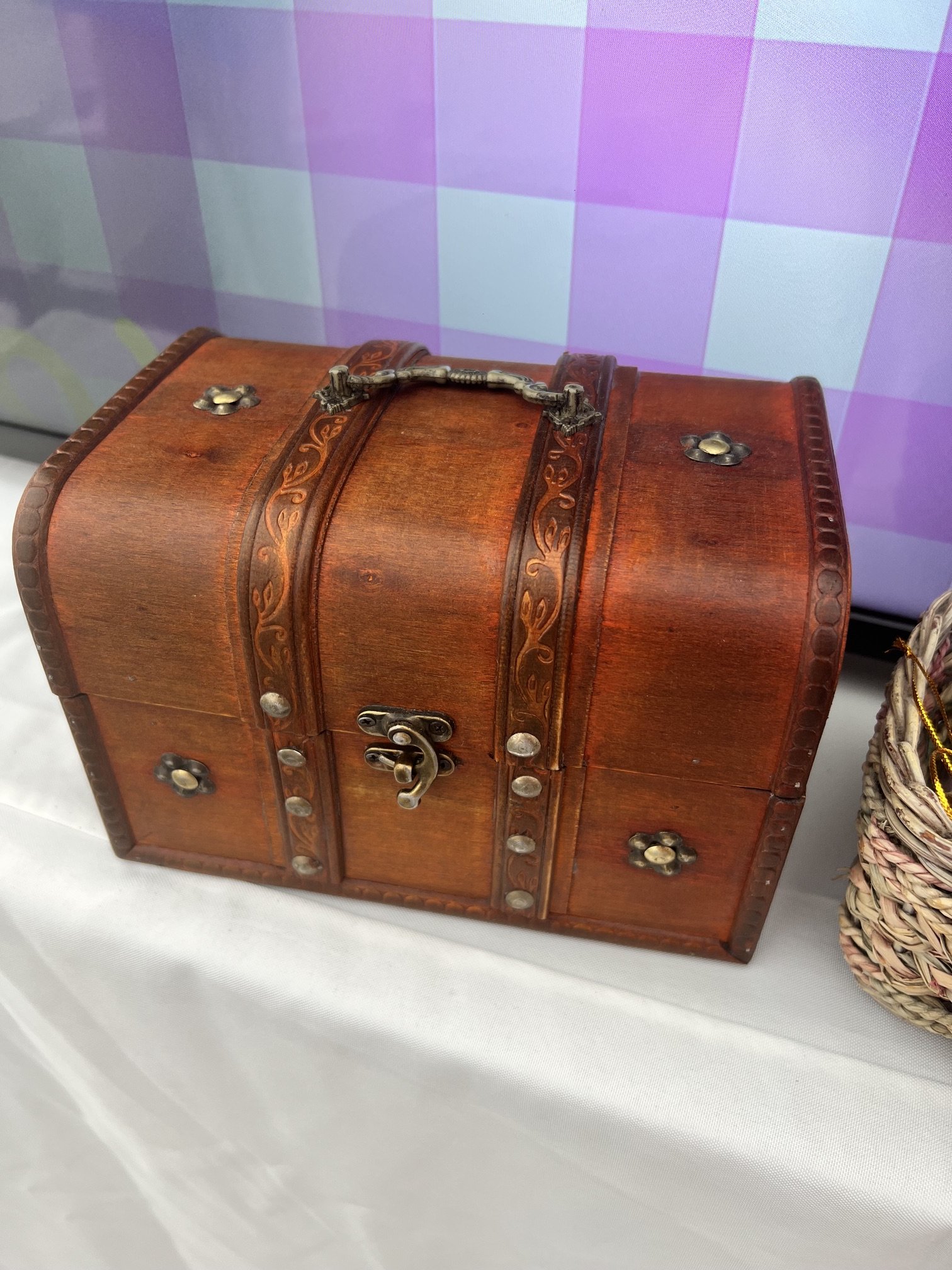 A brown box that looks like a pirate's treasure chest, with bronze studs and a clasp.