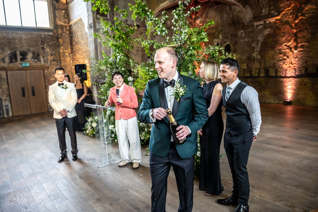 James about to pop a bottle of champagne.