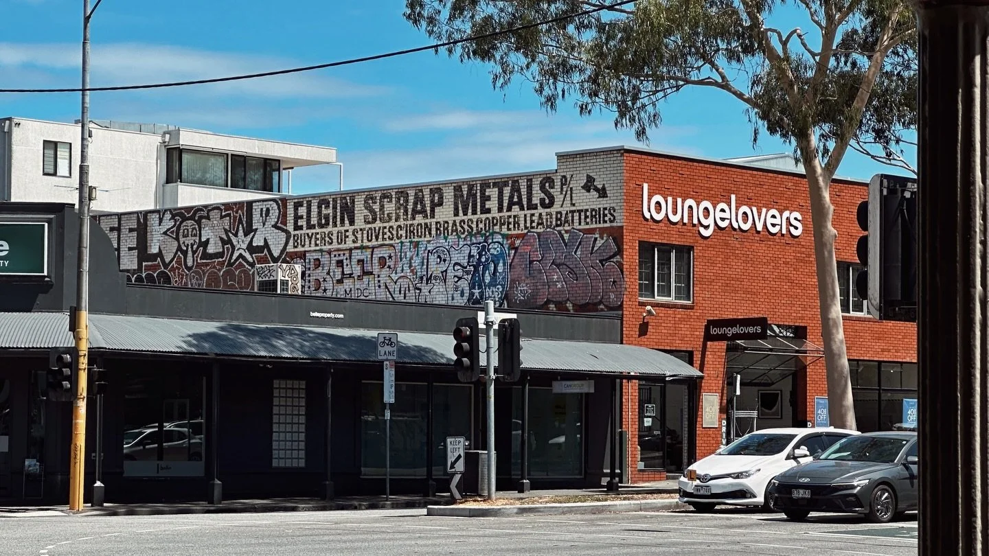 The Arrow That Points Back

ELGIN SCRAP METALS P/L
BUYERS OF STOVES, IRON, BRASS, COPPER, LEAD, BATTERIES
And that magnificent arrow&mdash;whimsical, stylish, practical&mdash;pointing you straight toward the mouth of the warehouse.

At Elgin Street n