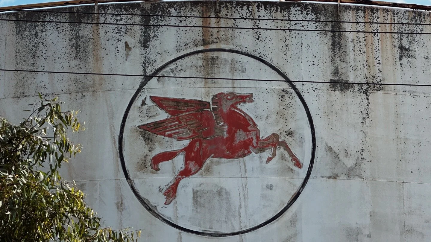 Mobil Oil Pegasus
Yarraville Terminal, Francis Street

There are parts of Melbourne&rsquo;s inner west where the air still tastes like industry.

Not metaphorically. Literally.

Francis Street: where road trains thunder past, chewing the asphalt to p