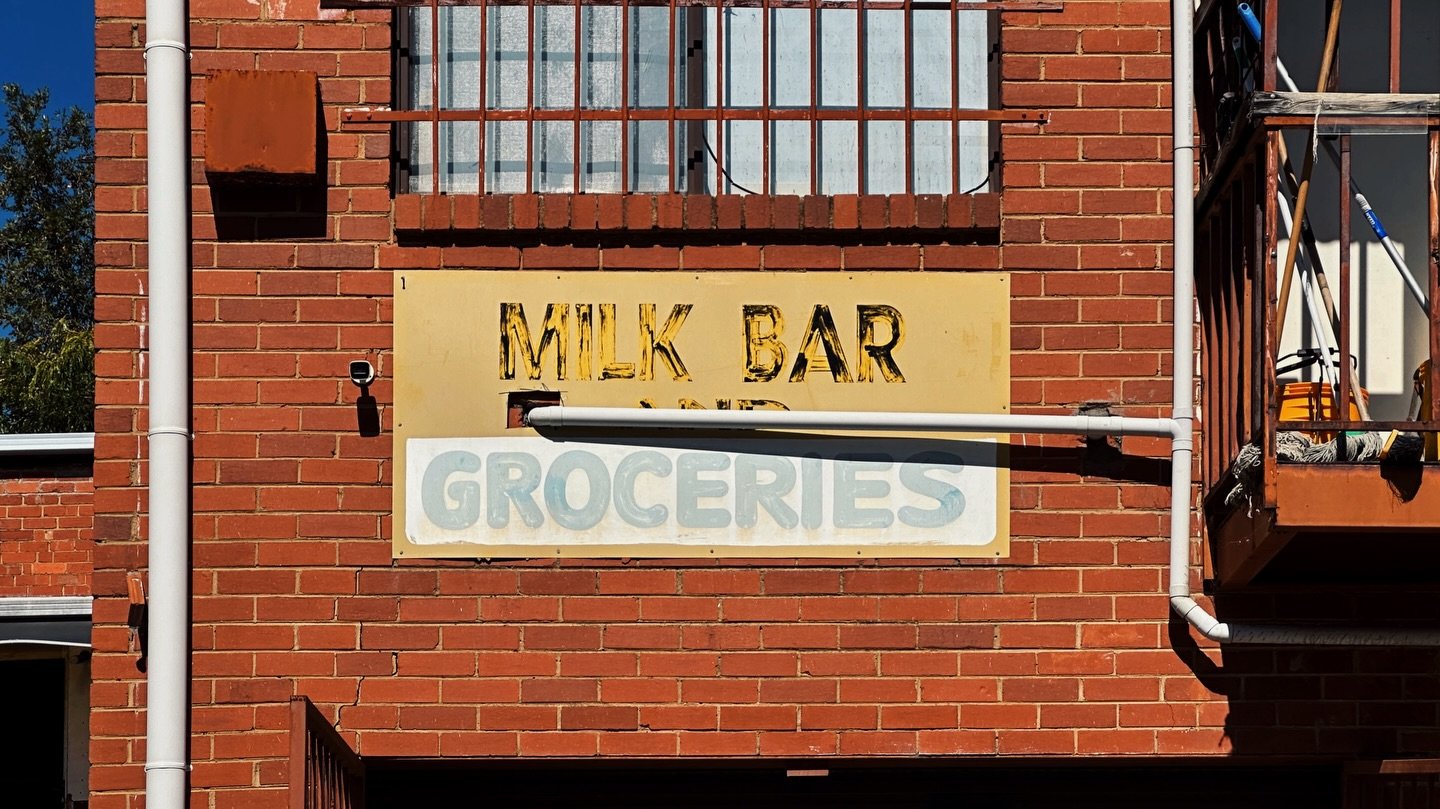 Behind a former milk bar in Box Hill North, there&rsquo;s a ghost signs.

MILK BAR AND GROCERIES

From a time when a corner shop could anchor a whole suburb. Milk. Bread. Cigarettes. A kid sent with coins sweating in a clenched fist and strict instru