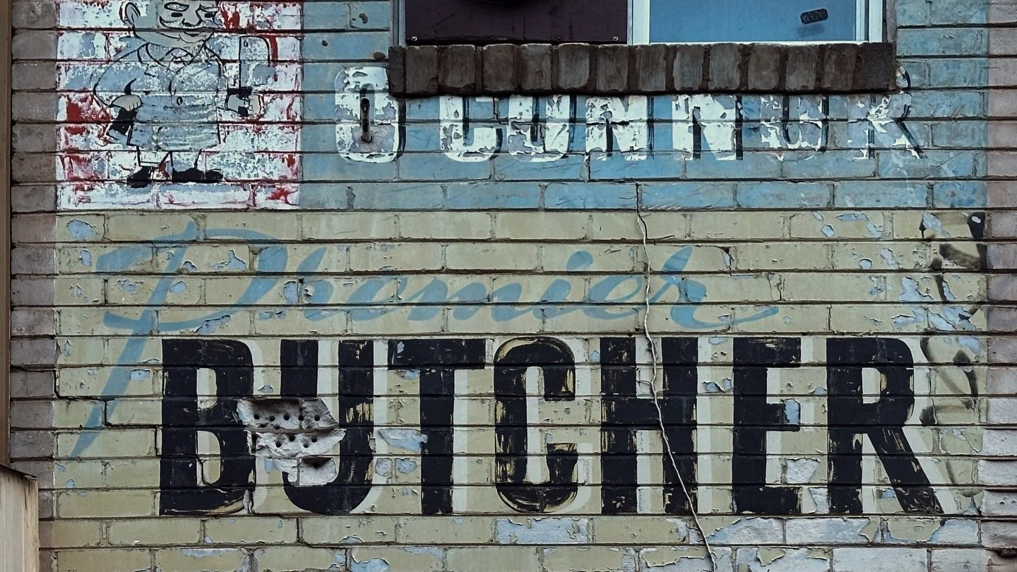 The Butcher of Belgrave

There is a butcher in Belgrave with his face still on the wall.

Leo Desmond O&rsquo;Connor is gone. The shop has changed. The town has changed. The old meat economy of the Dandenong Ranges has mostly been carved up, wrapped 