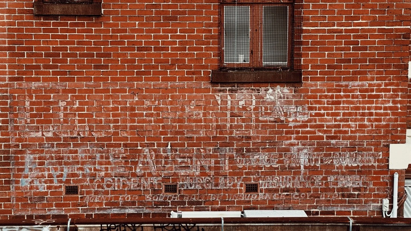 The sign is still there on a wall in Canterbury, a century after it was painted.

L. G. STEVENS / ESTATE AGENT / AGENT FOR SOUTH BRITISH INSURANCE COY LTD

Almost faded to oblivion. Still claiming space.

Lewis Garfield Stevens was dead at 28. He die
