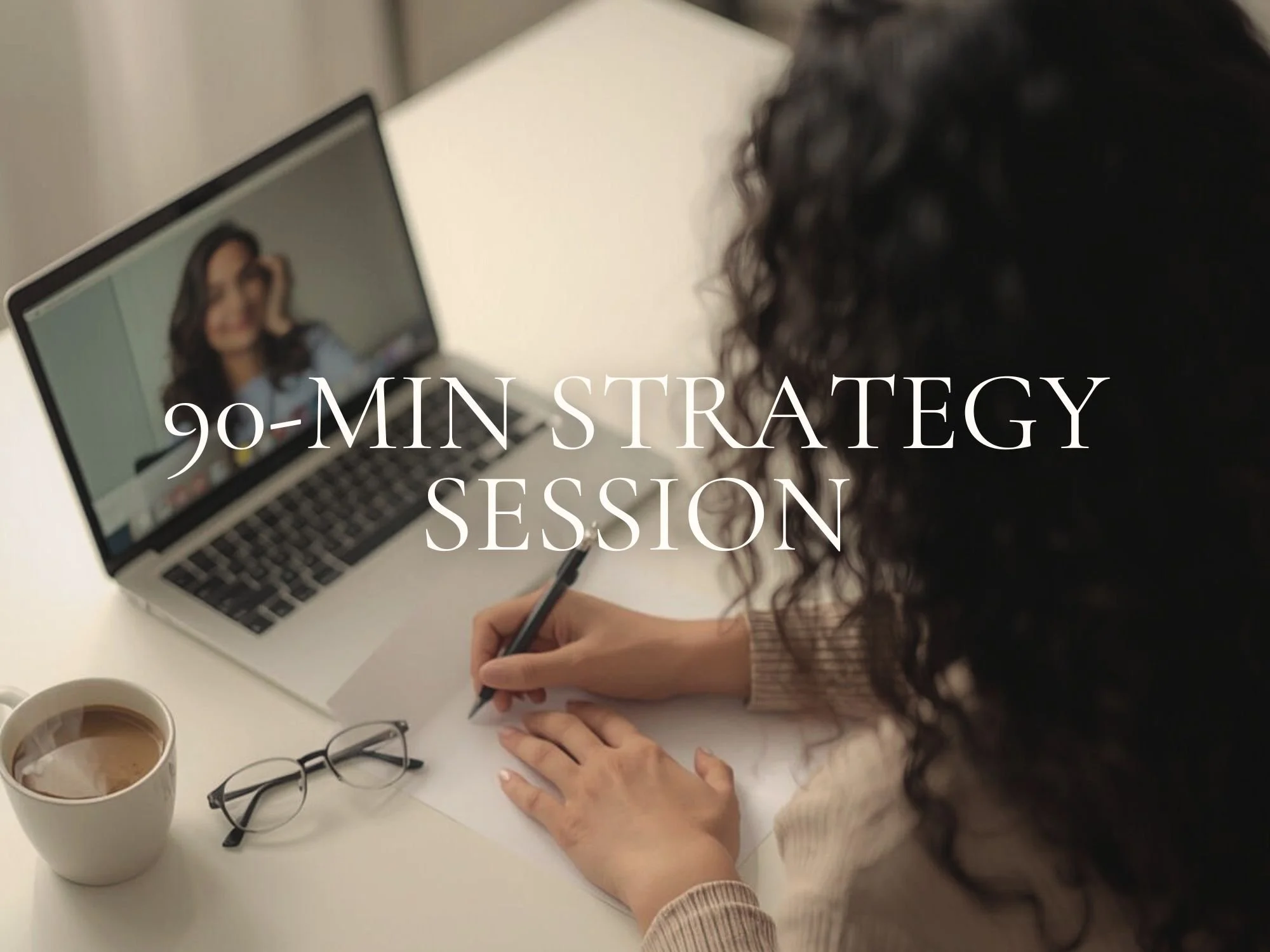 A woman participating in a 90-minute strategy session via video call on her laptop, taking notes on paper.