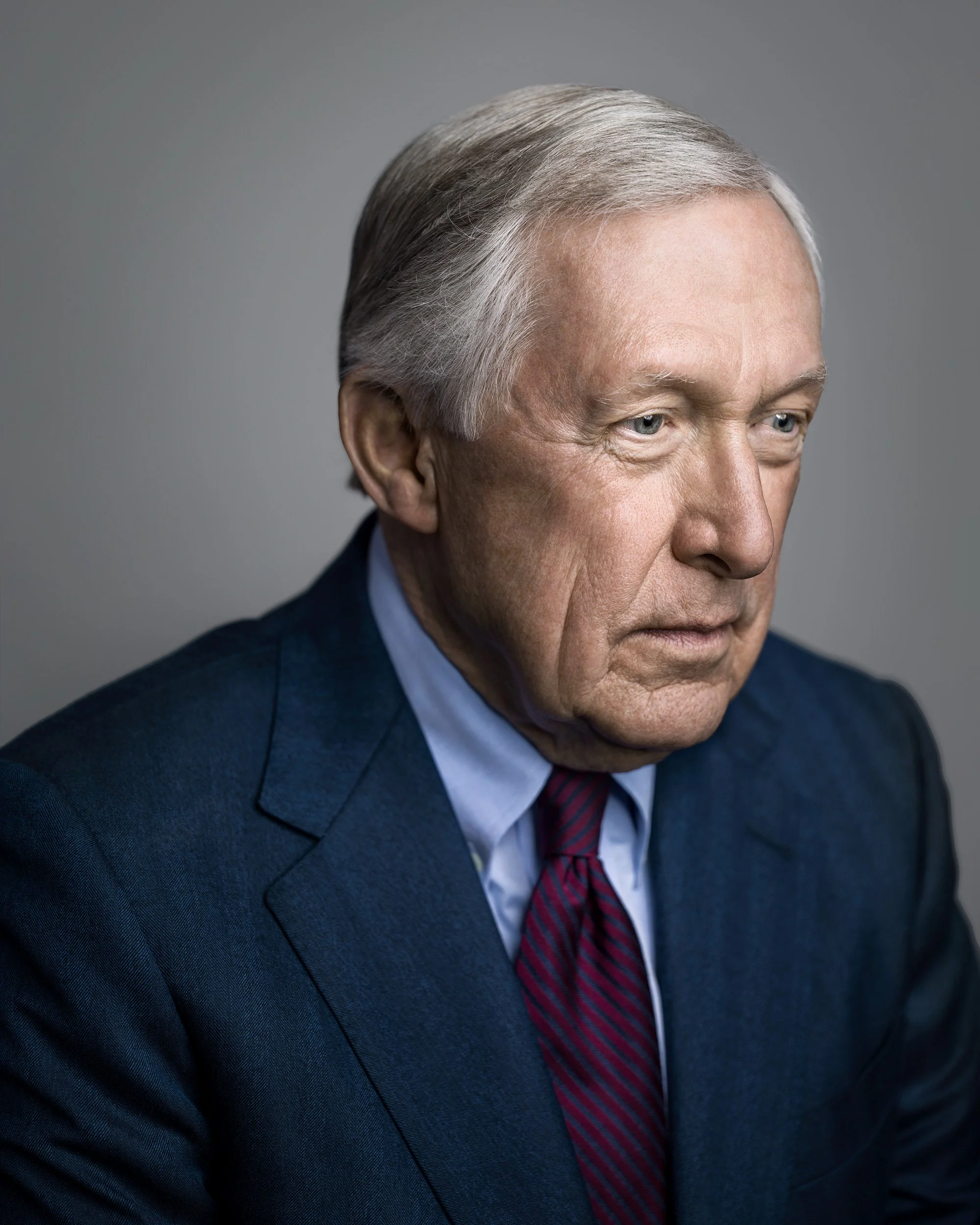 CEO headshots studio portrait, male founder; balanced constant light on neutral gray; slight angle for modern authority.