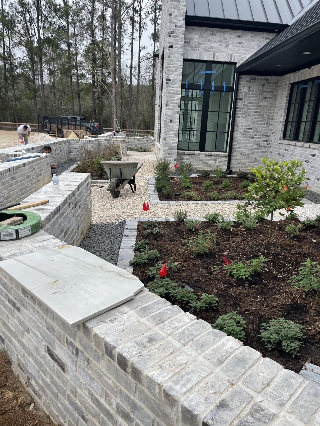 Courtyard brick planter walls with new plantings