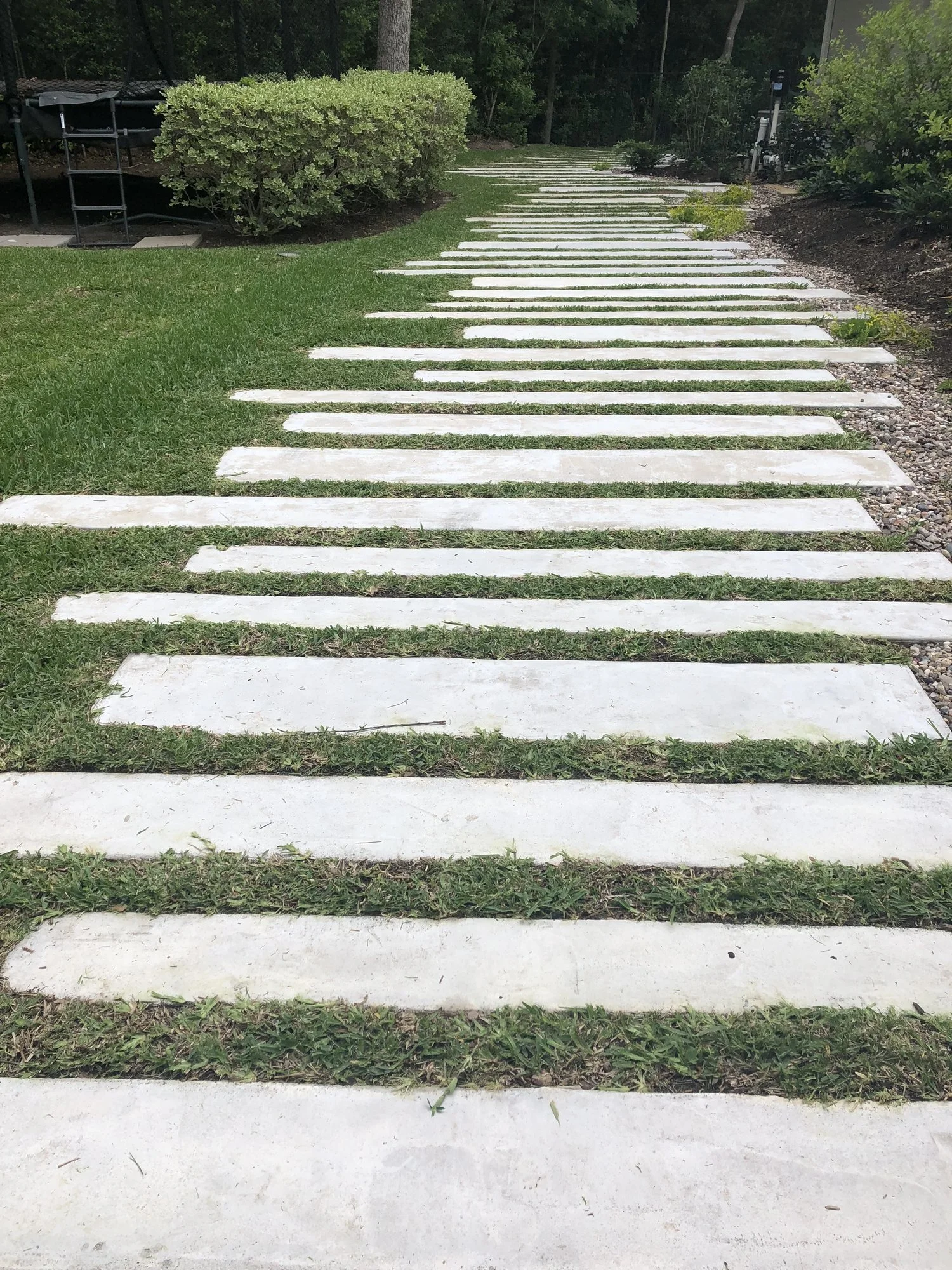 Trinity Oaks, Heritage Hills: hand-formed concrete plank walkway stepping through the lawn