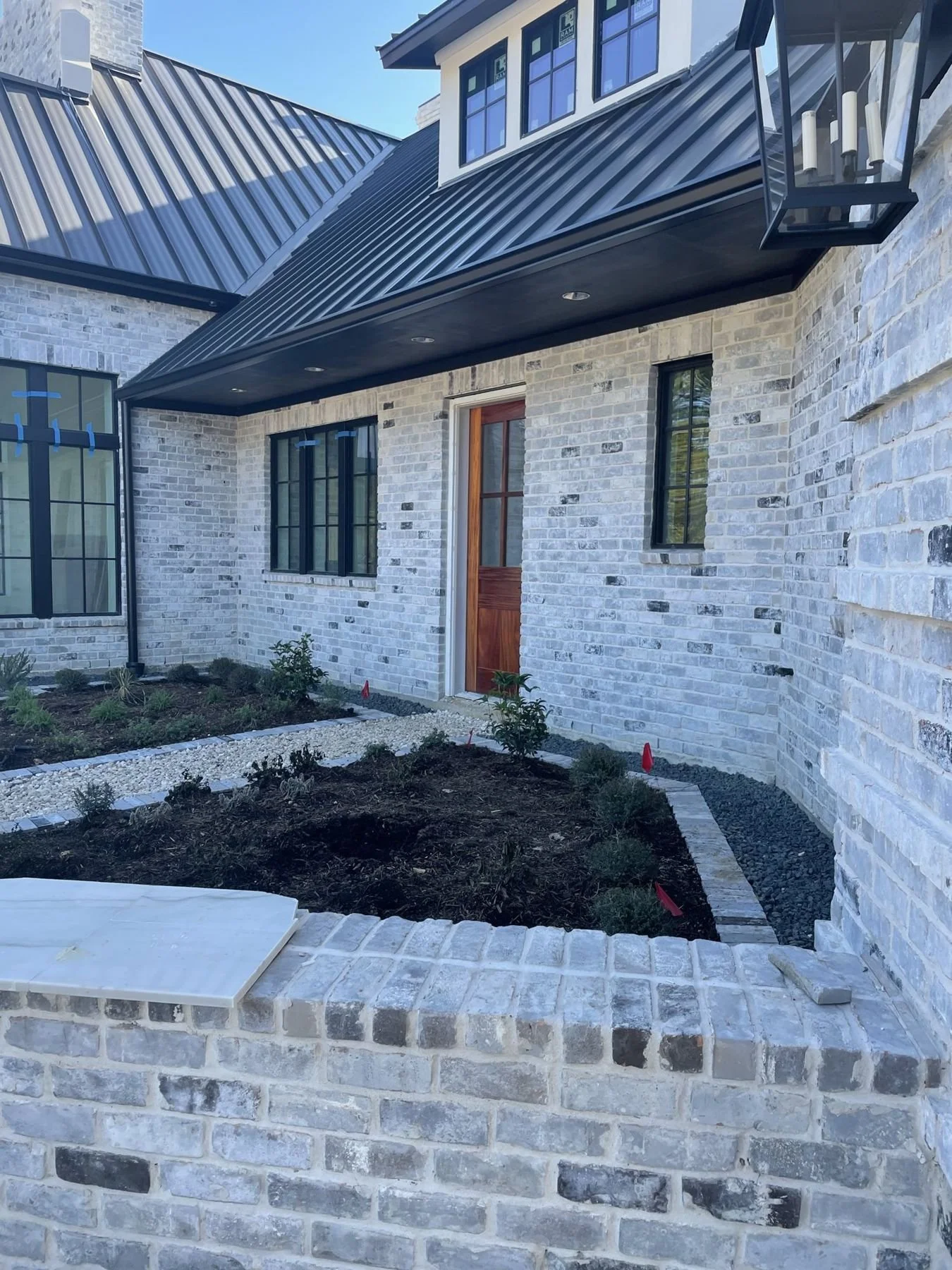 Brick raised bed planted at the front door