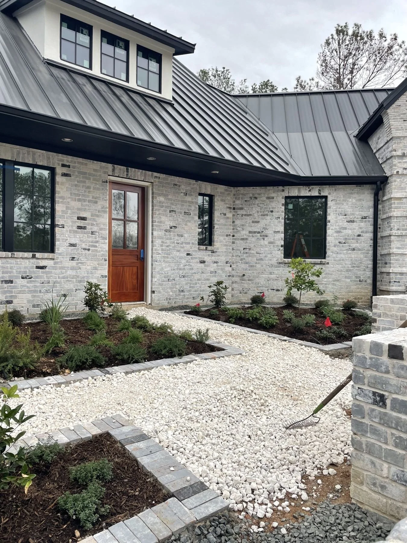 Front courtyard: gravel walk and brick-edged beds