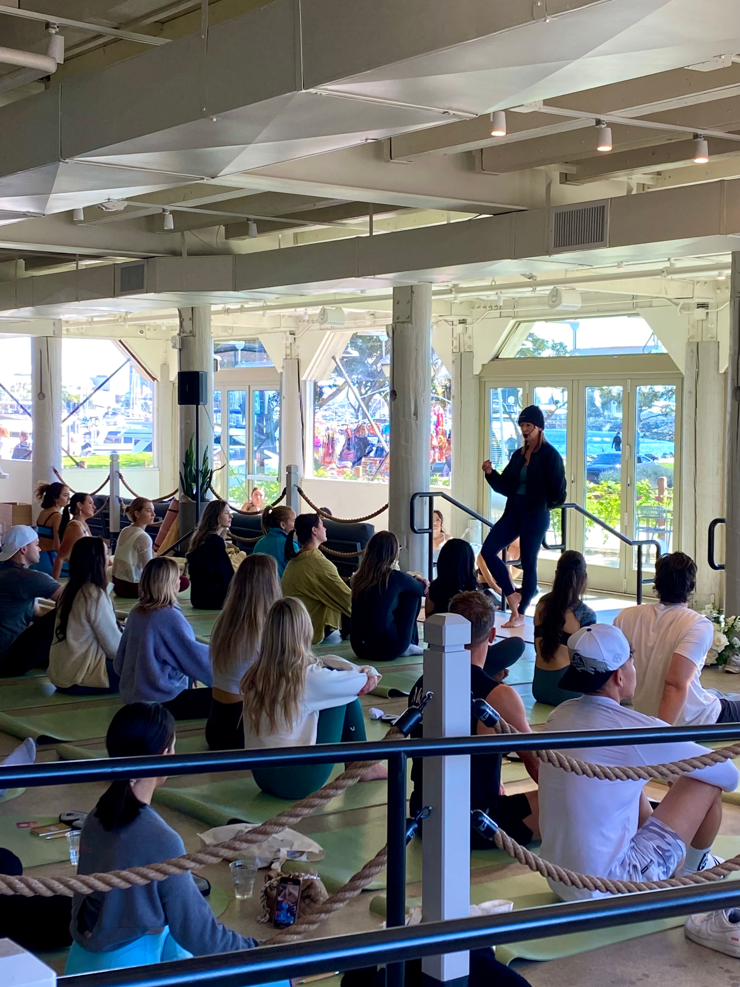 Malin Hornkvist leading a yoga and breathwork event overlooking the marina in San Diego.