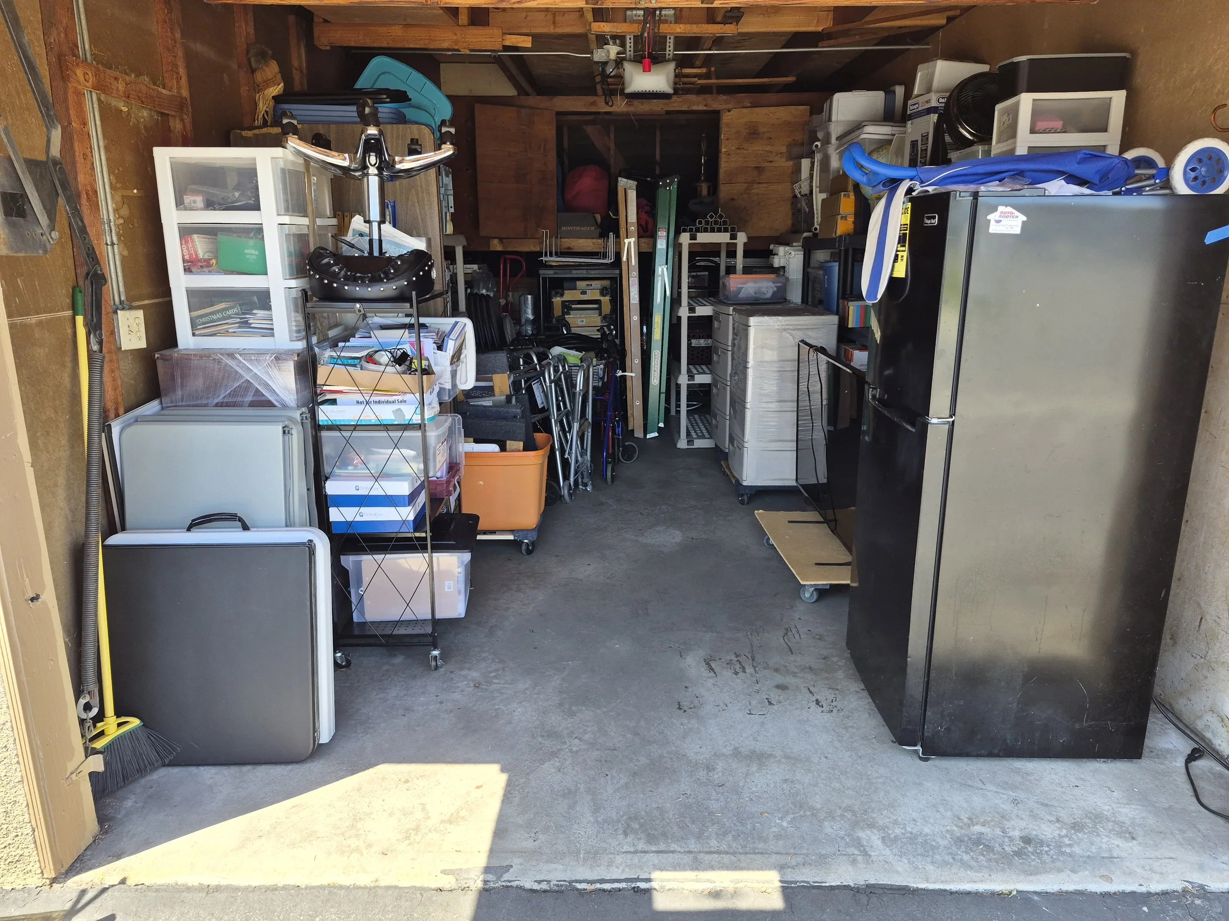 After - Still a work in progress but now there is space to stage and continue an organized move in to the new home while having clear access to garage items. 