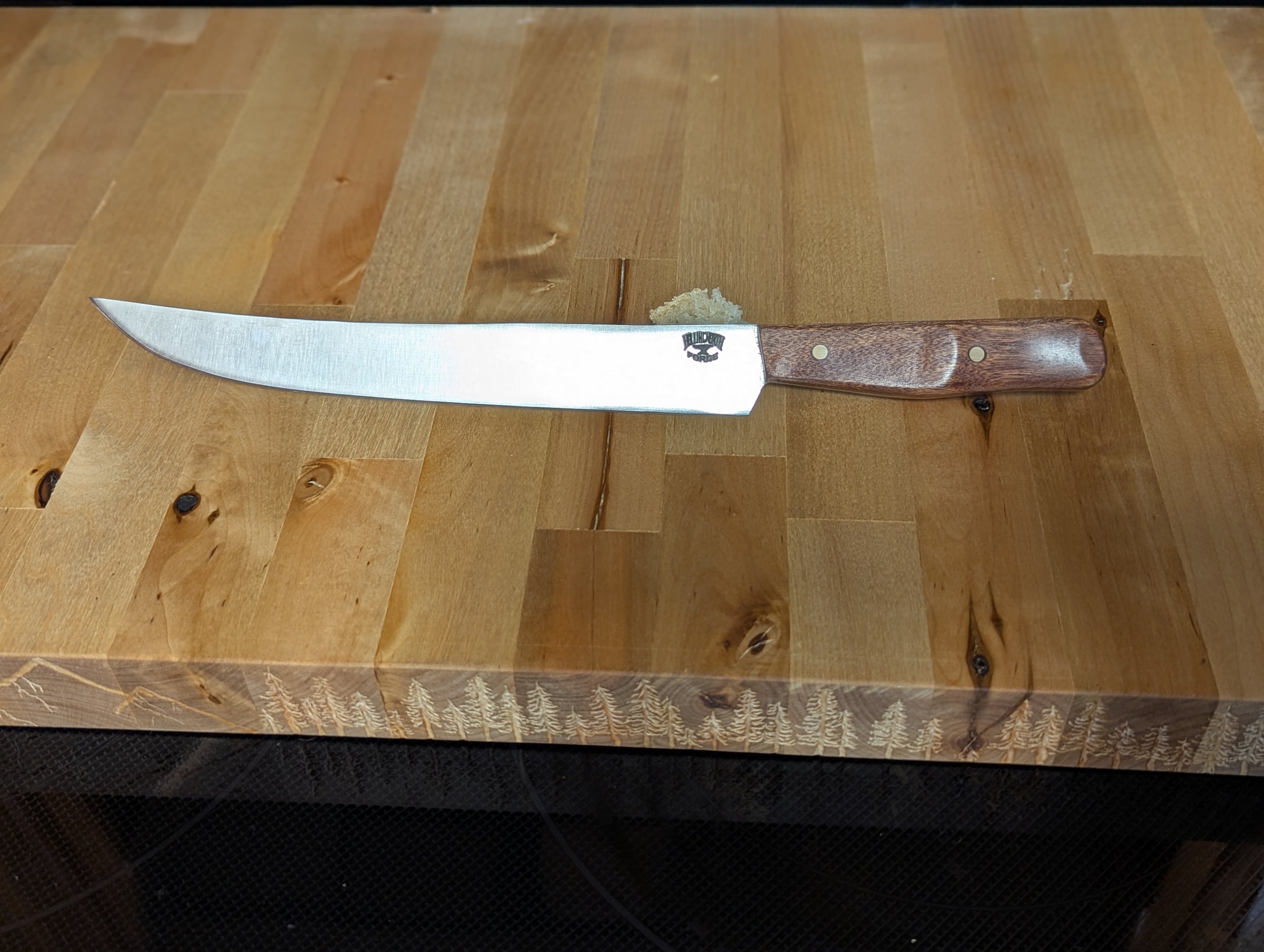 9.5" Brisket slicer, 440c stainless steel, Patagonian Rosewood handle with brass pins.
