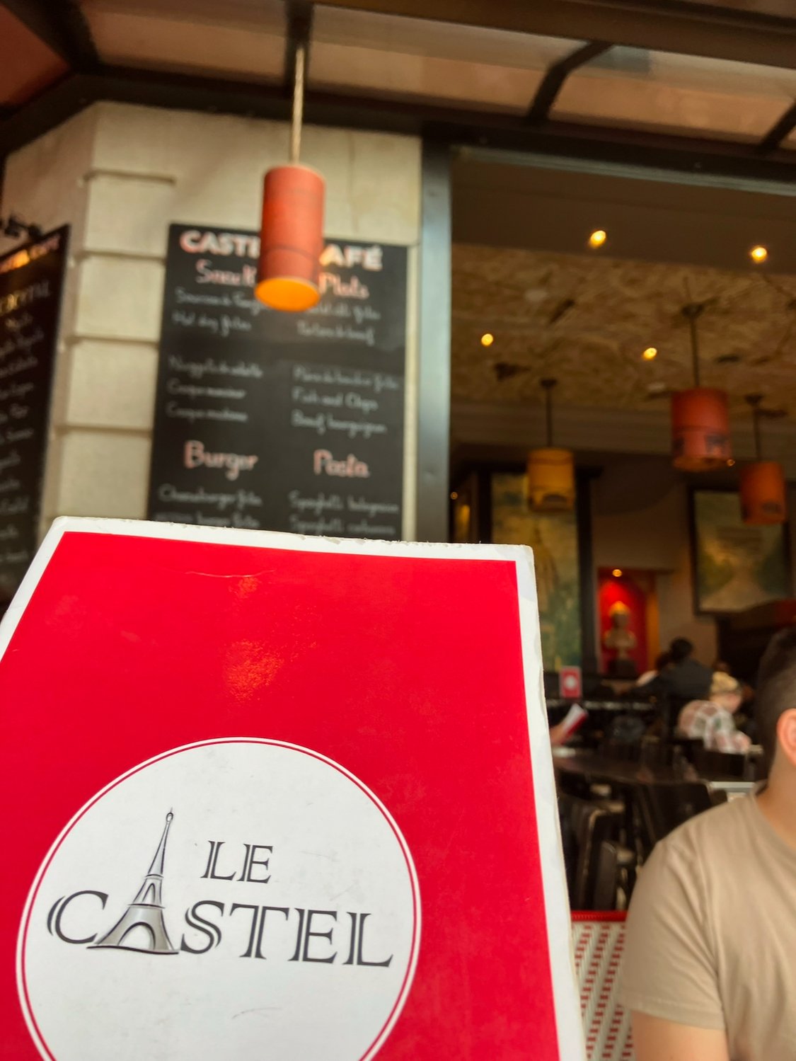 Red menu cover with the words 'Le Castiel' and an illustration of the Eiffel Tower.