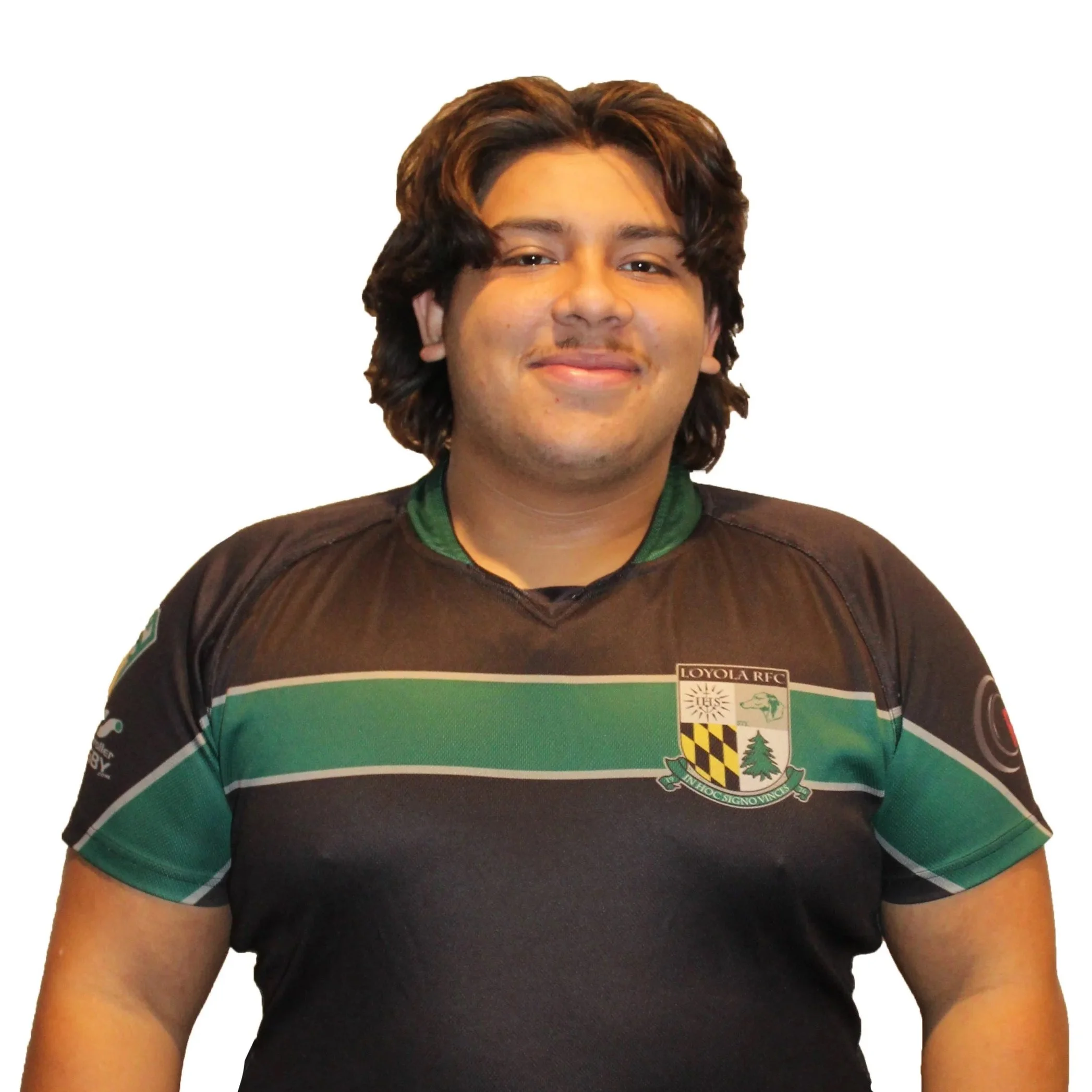 Young male in rugby jersey with team logos, light background.