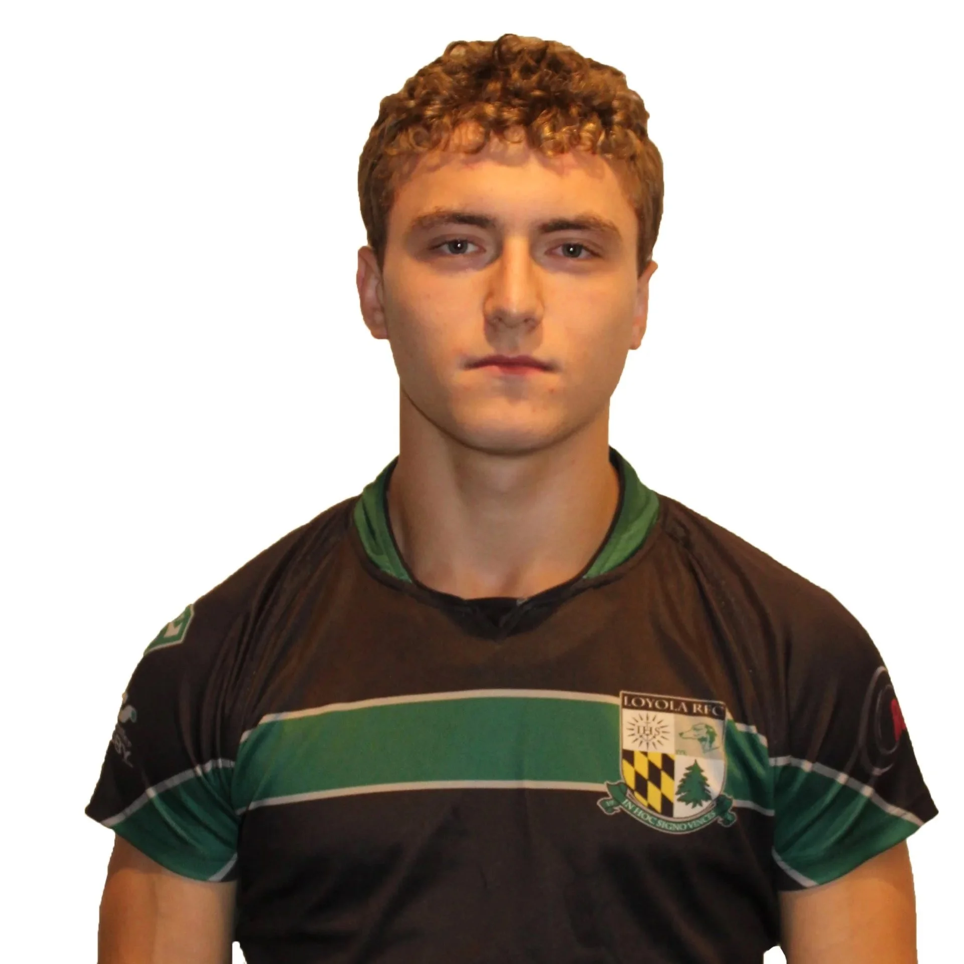 Portrait of a young man wearing a dark sports jersey with green accents, standing with arms crossed.