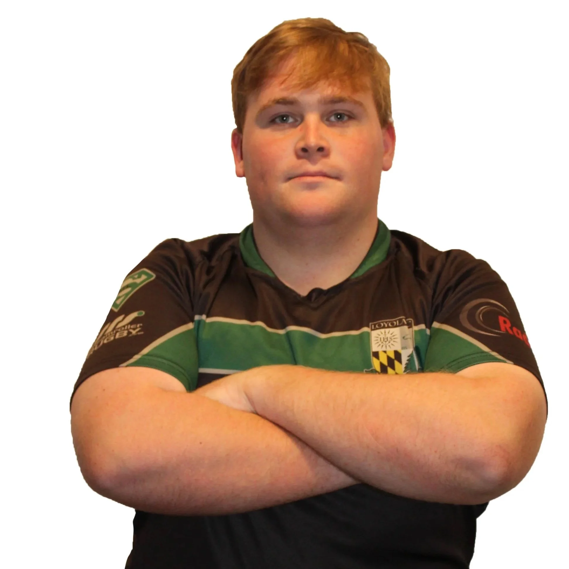 Young man in black and green sports jersey with arm badge and crest emblem standing against a plain background.
