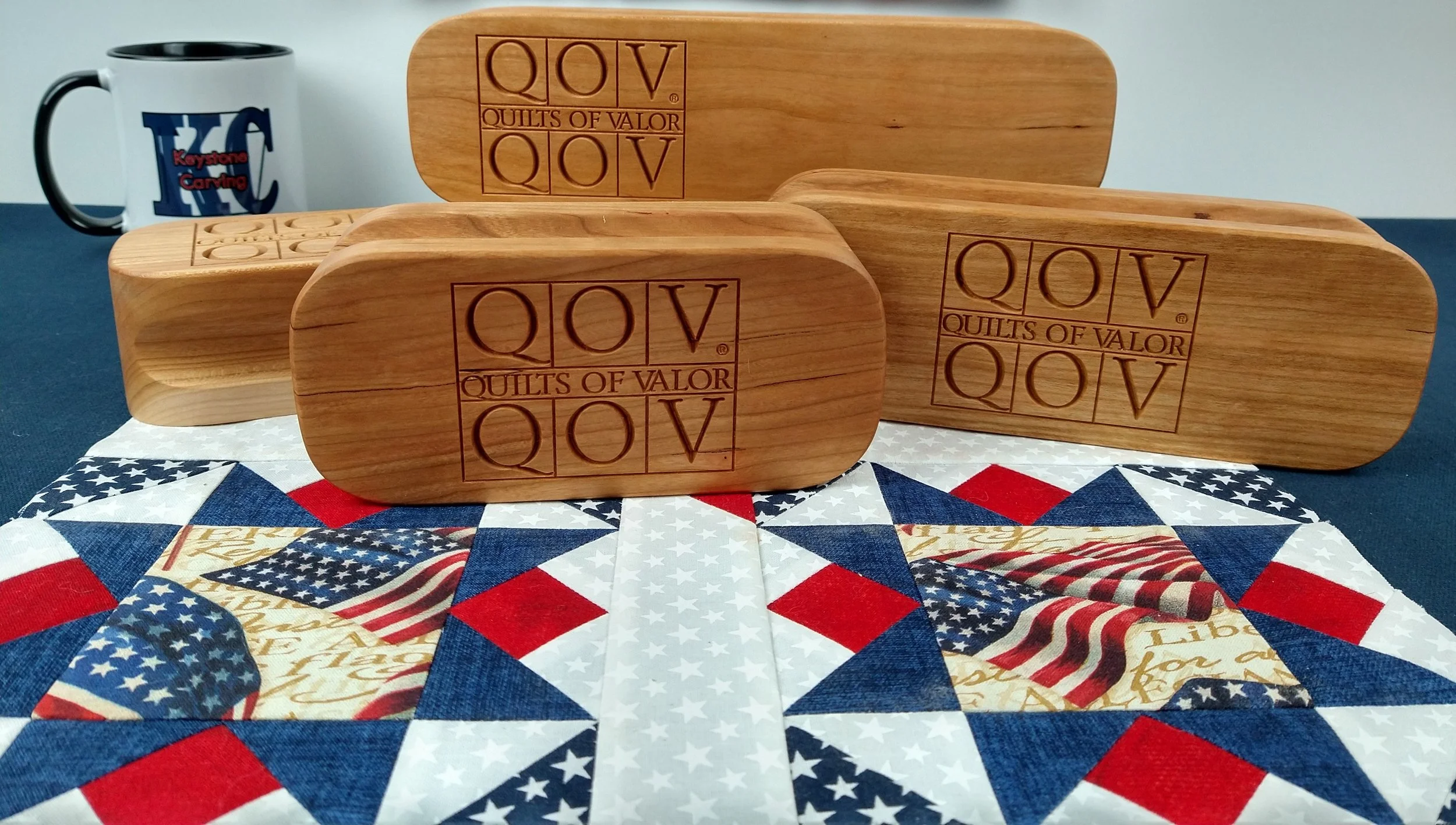 Quilters Clapper with 'Quilts of Valor' logo, patriotic quilt pattern, Keystone Carving LLC.