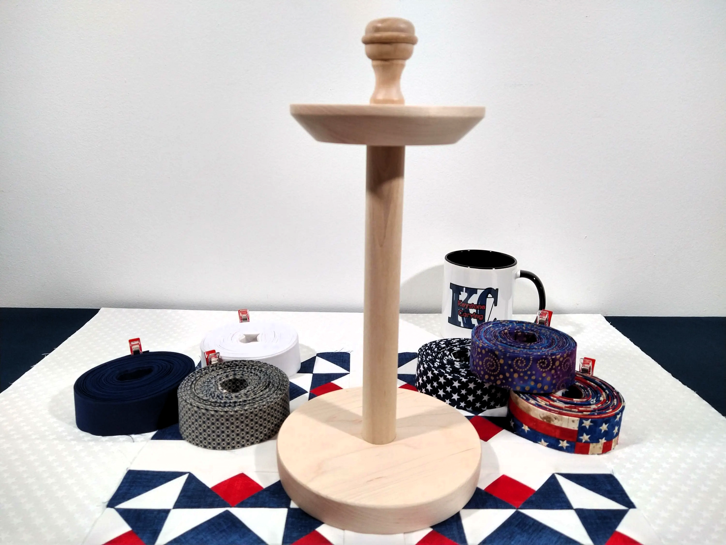 quilt binding storage organizer with its top installed . The binding organizer is on a red white and blue quilt block