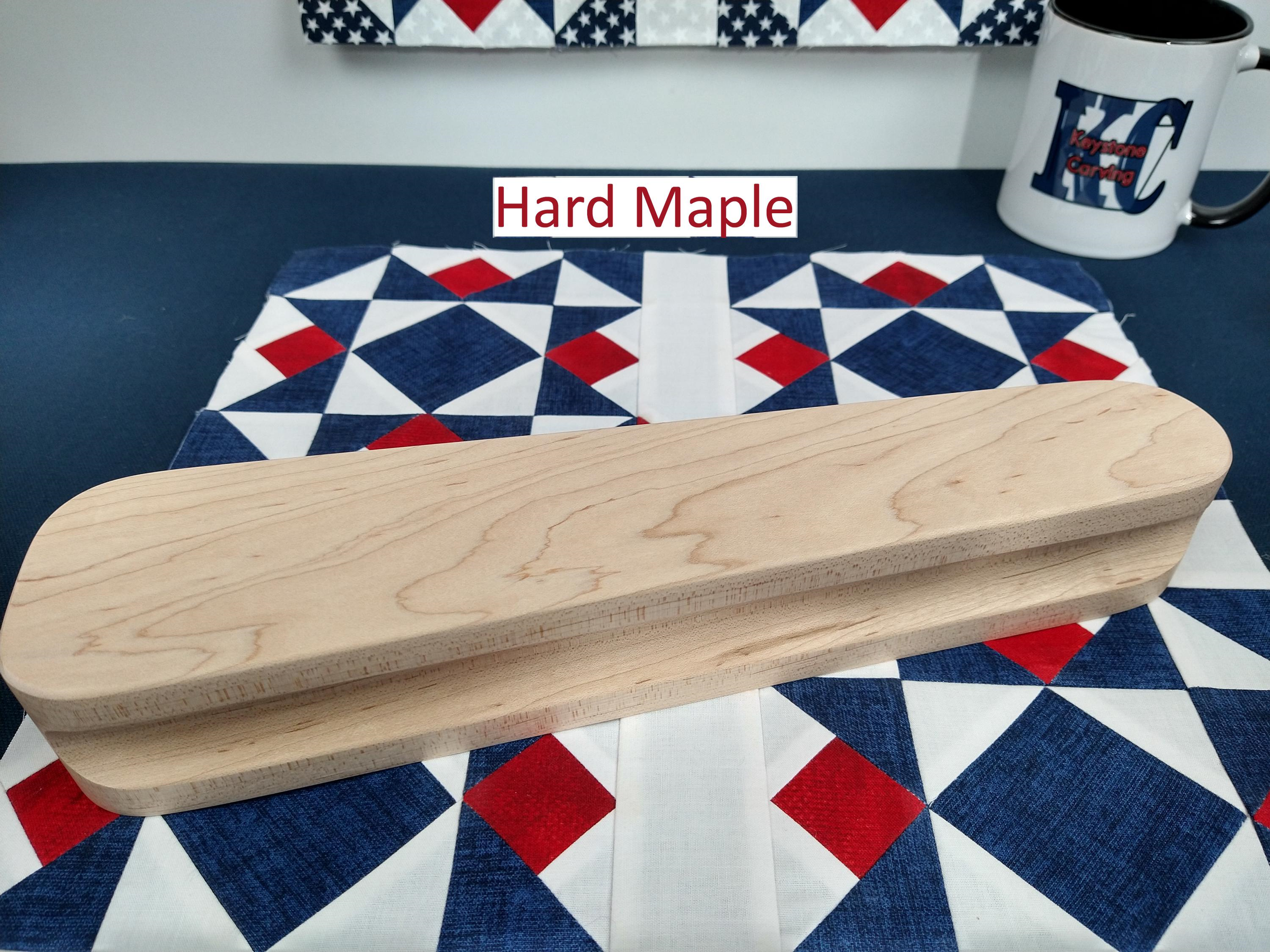 twelve and one half inch tapered maple hardwood tailors clapper setting on an Americana quilt block