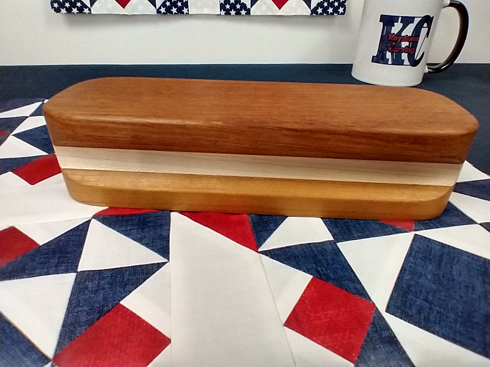 Side view of a Brazilian cherry, maple, and cherry quilters clapper