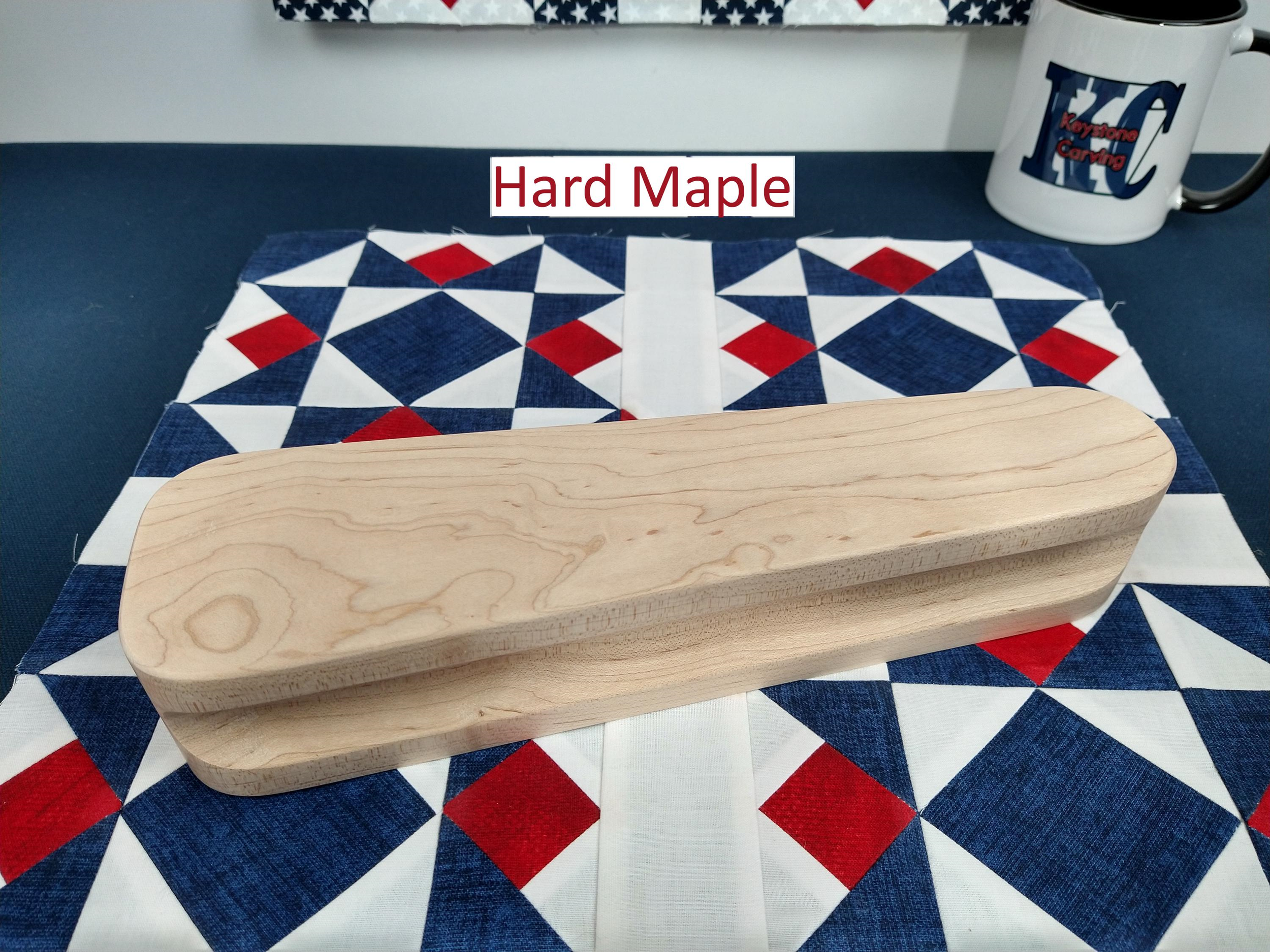 ten and one half inch tapered cherry hardwood tailors clapper setting on an Americana quilt block